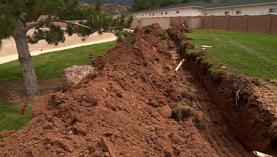 A newly dug-up, deep trench near Intermountain Cedar City Hospital is supposed to divert flood water away from the building.