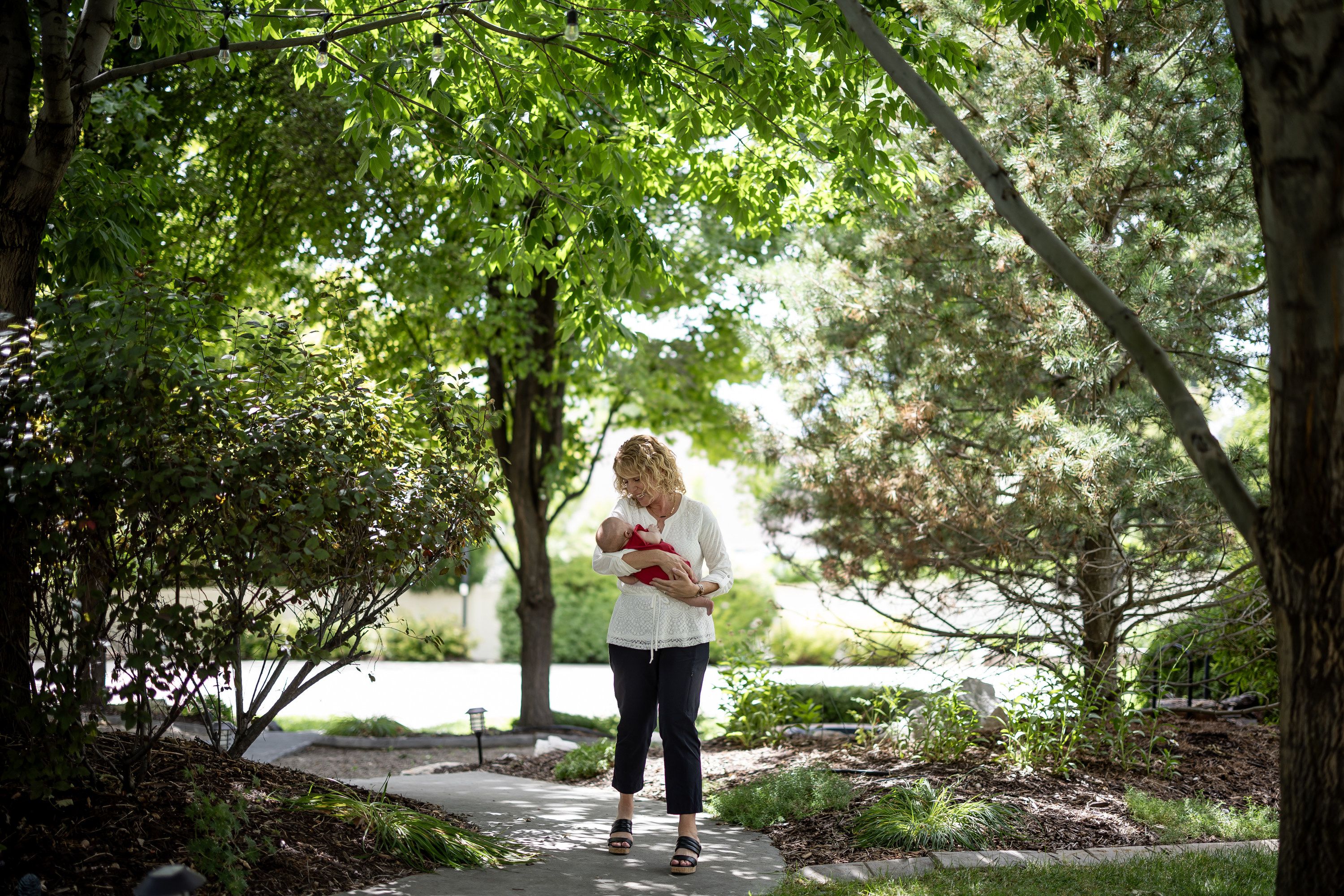 Cindy Davis walks through her backyard with her 9-week-old granddaughter Indy while babysitting her at home in Cedar Hills on Tuesday. Grandparenting can boost grandkids’ sense of security and help grandparents live happier and longer lives, experts say.