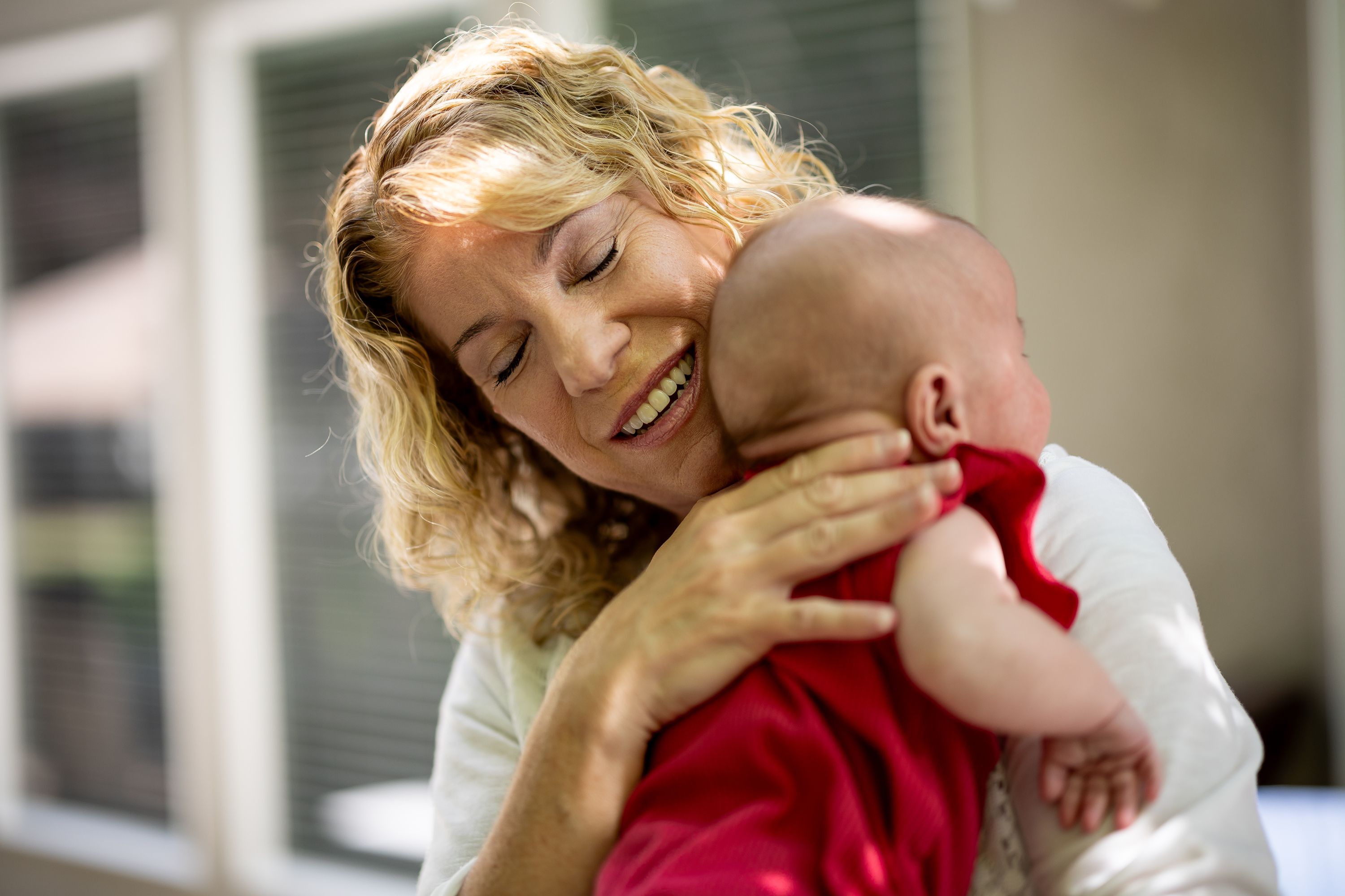 Cindy Davis holds her 9-week-old granddaughter Indy while babysitting her at home in Cedar Hills on Tuesday. Grandparenting can boost grandkids’ sense of security and help grandparents live happier and longer lives, experts say.
