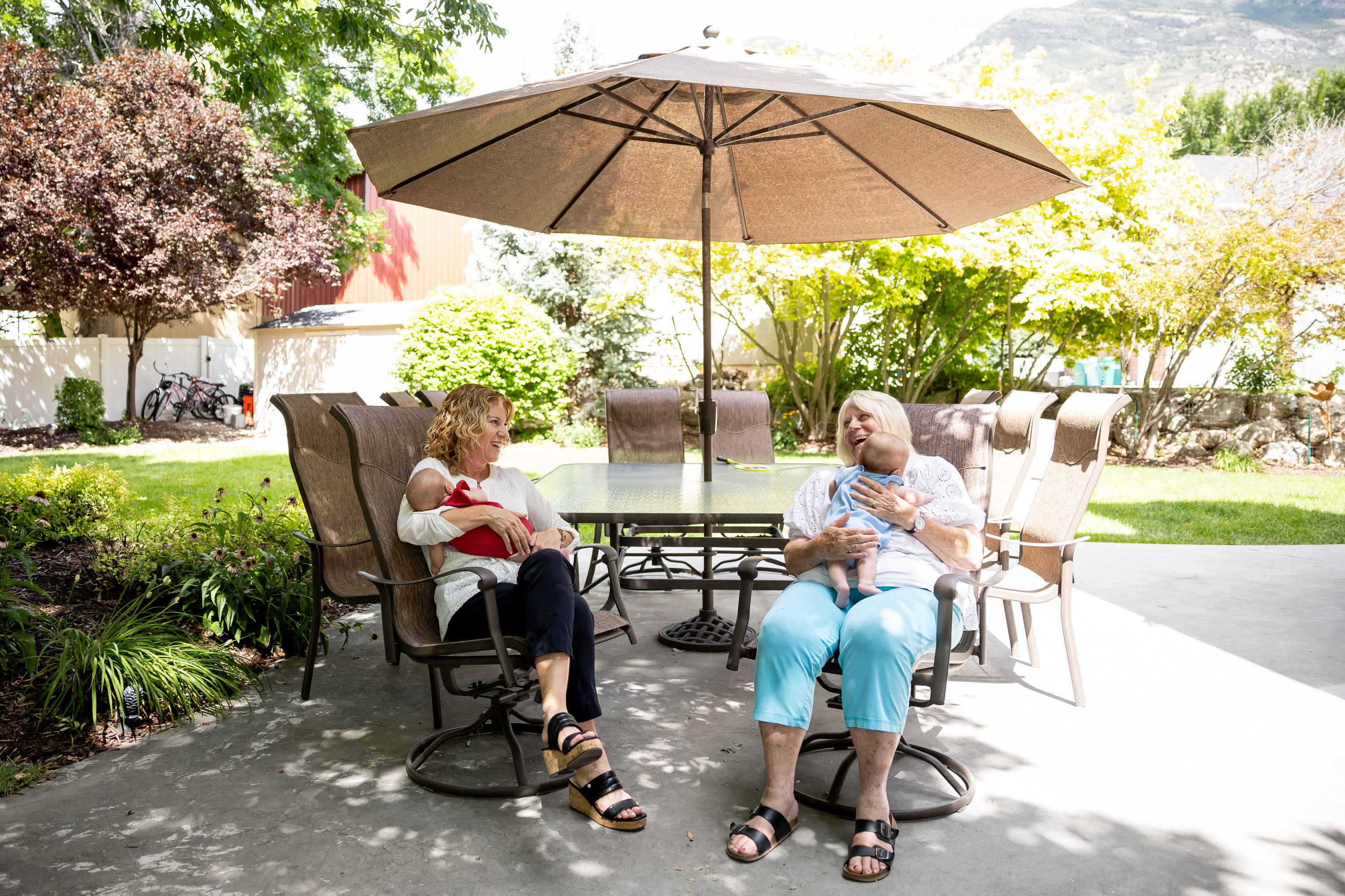 Cindy Davis and her mother Camie Bishop Calaway sit together in Davis’ yard while babysitting 9-week-old twins Indy and Oakley, who are Davis’ granddaughters and Calaway’s great-granddaughters, in Cedar Hills on Tuesday. Grandparenting can boost grandkids’ sense of security and help grandparents live happier and longer lives, experts say.