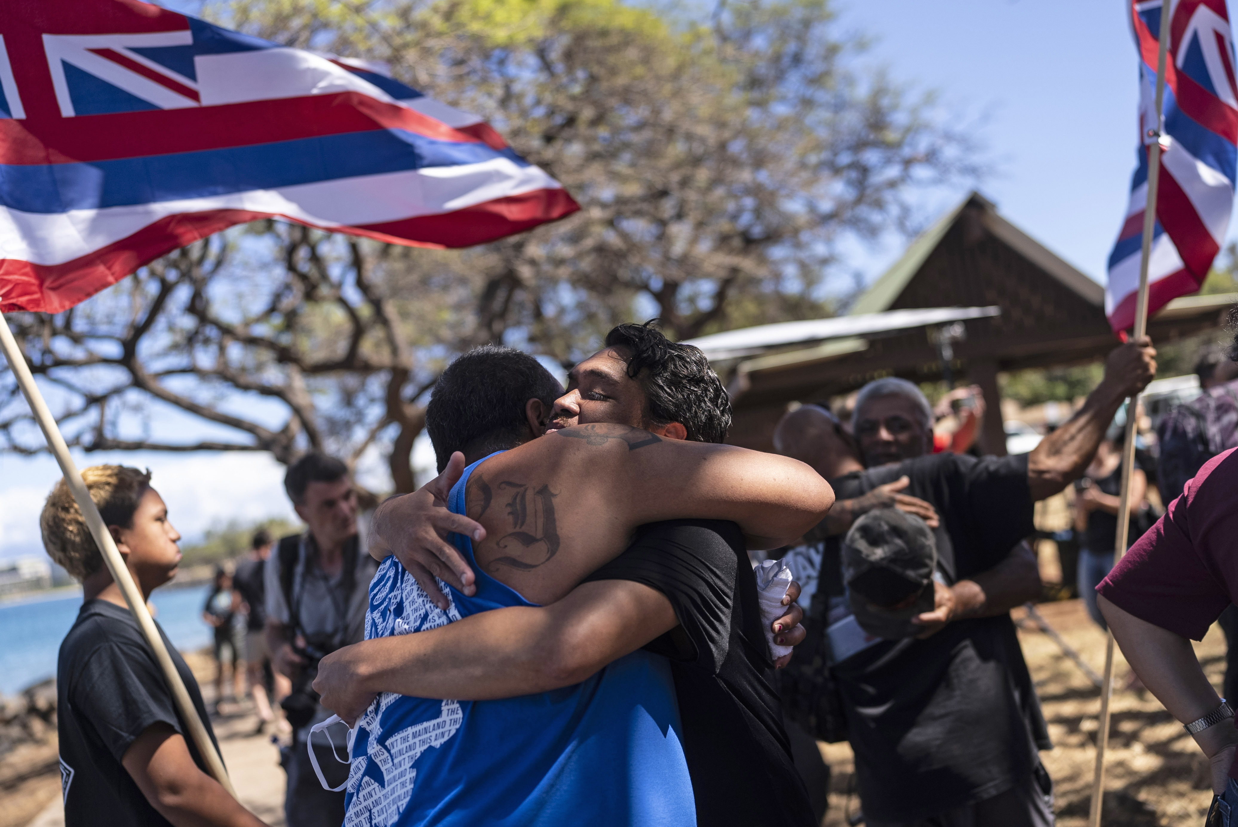 Lahaina, Hawaii, residents, who are affected by a deadly wildfire that devastated the community, hug one another after a news conference in Lahaina, Hawaii, Friday. Hawaii Gov. Josh Green says the future of a Maui community devastated by deadly fire will be determined by its people.