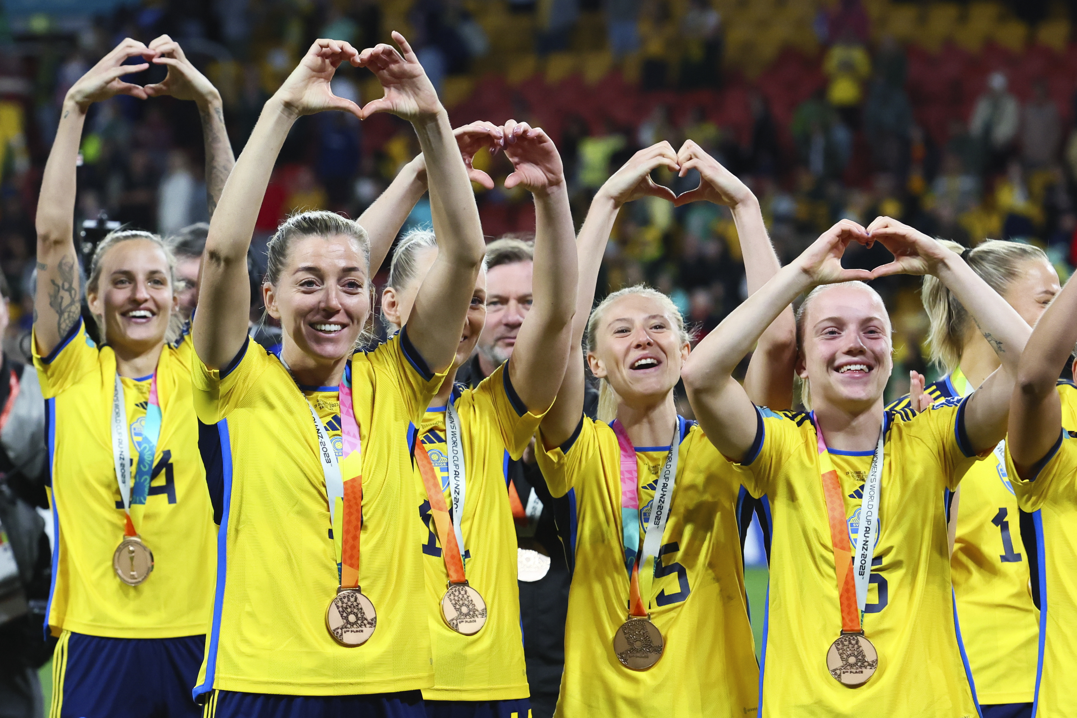 Sweden gesture to supporters as they celebrate with their bronze medals after defeating Australia in the Women's World Cup third place playoff soccer match in Brisbane, Australia, Saturday, Aug. 19, 2023. 