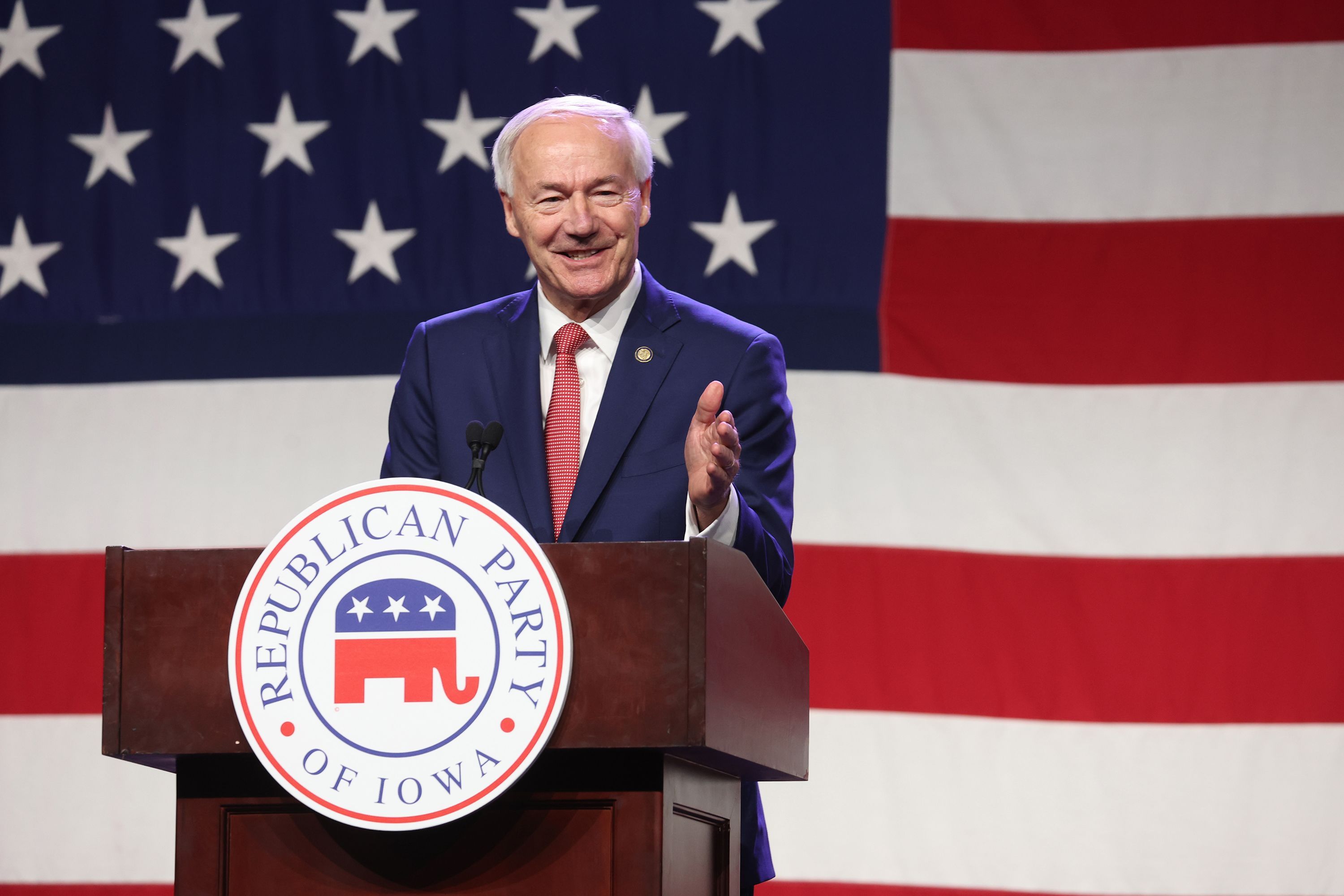 Former Arkansas Gov. Asa Hutchinson, a Republican presidential candidate, speaks in Iowa on July 28. He says he has qualified for the first GOP presidential debate.