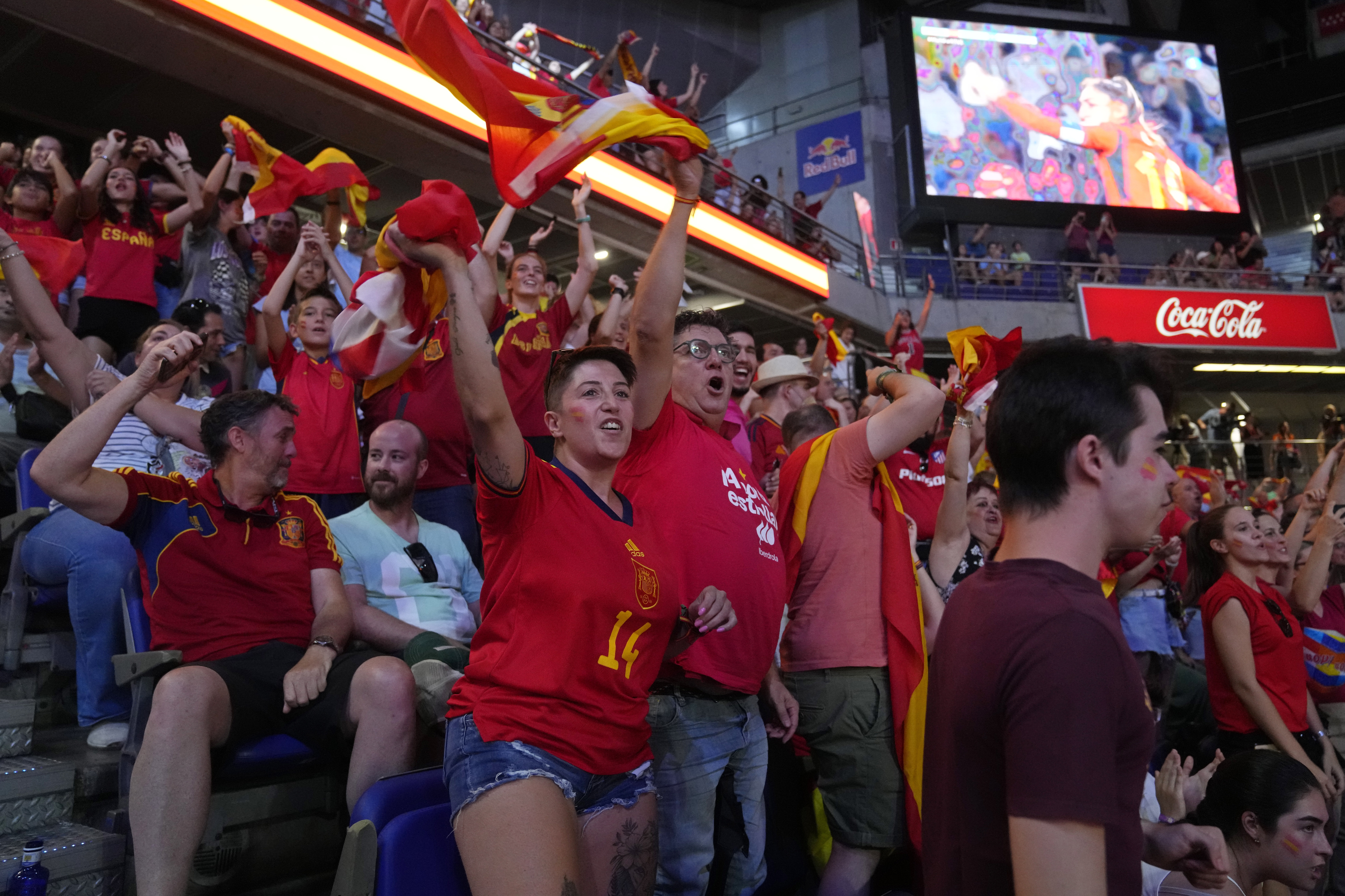 Spanish fans cheer in front of large screens after Spain's Olga Carmona scored the opening goal during the Women's World Cup final soccer match between Spain and England in Madrid, Spain, Sunday, Aug. 20, 2023.