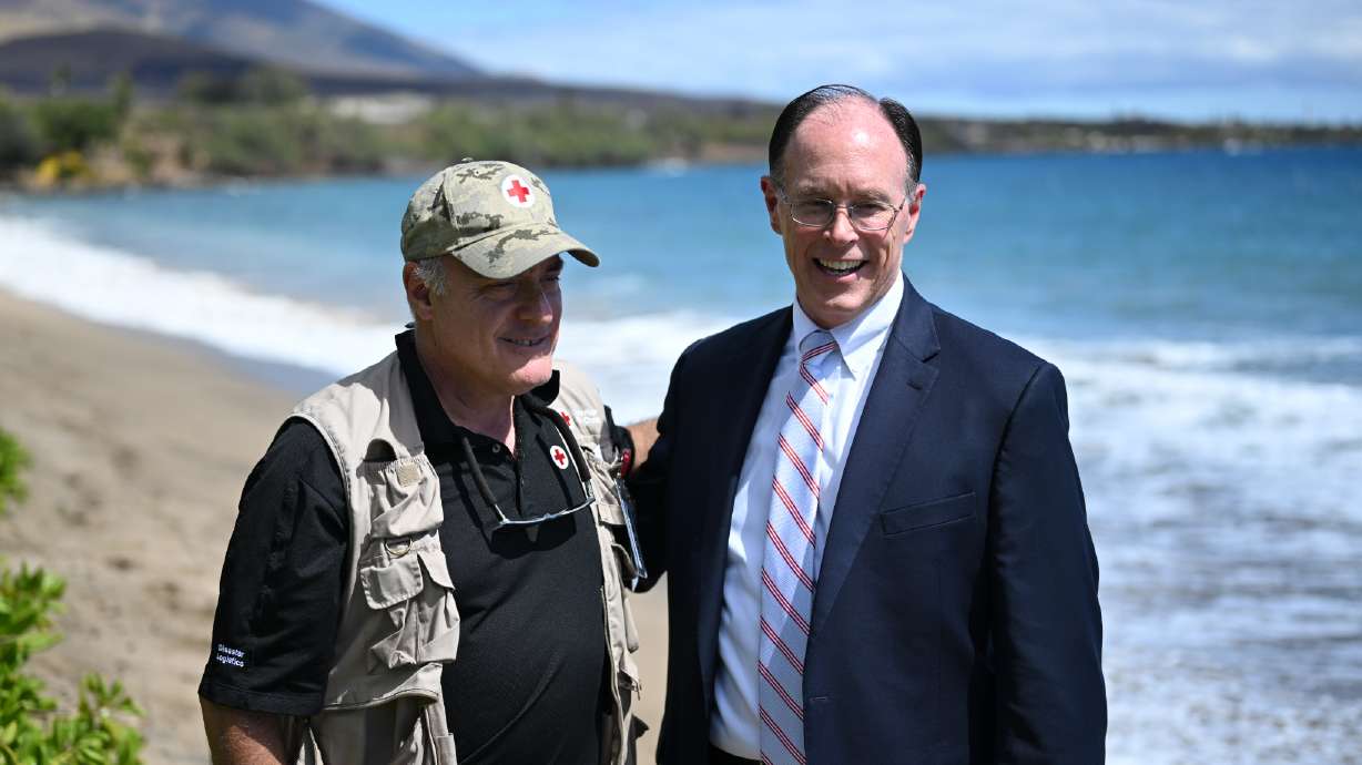 Brad Kieserman speaks with Bishop W. Christopher Waddell in Lahaina, Hawaii, on Sunday. The Church of Jesus Christ of Latter-day Saints announced a $1 million donation to the Red Cross to support its relief efforts after the Maui wildfires.