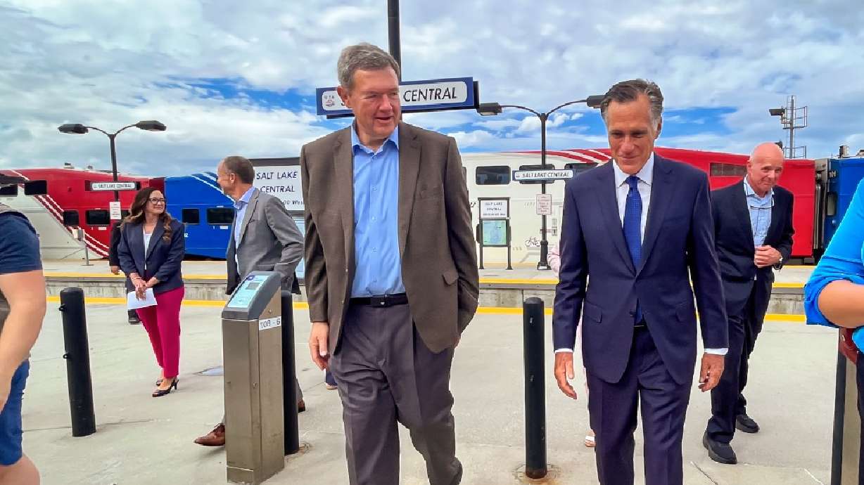 Utah Sen. Mitt Romney, right, speaks with Utah Transit Authority Board of Trustees Chairman Carlton Christensen at Salt Lake Central Station in Salt Lake City on Monday.