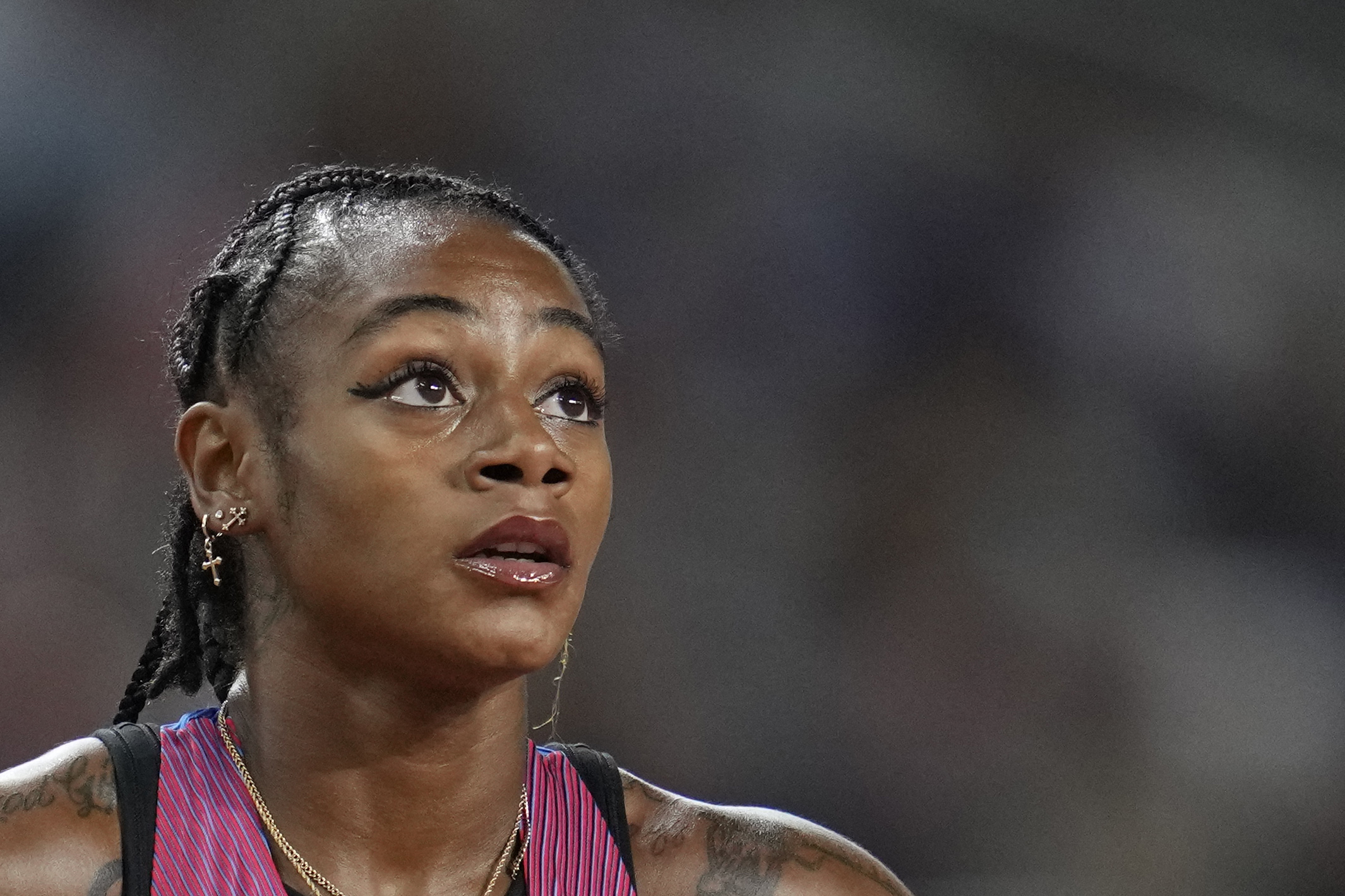 Sha'Carri Richardson, of the United States, reacts after her women's 100 meter semifinal heat during the World Athletics Championships in Budapest, Hungary, Monday, Aug. 21, 2023. 