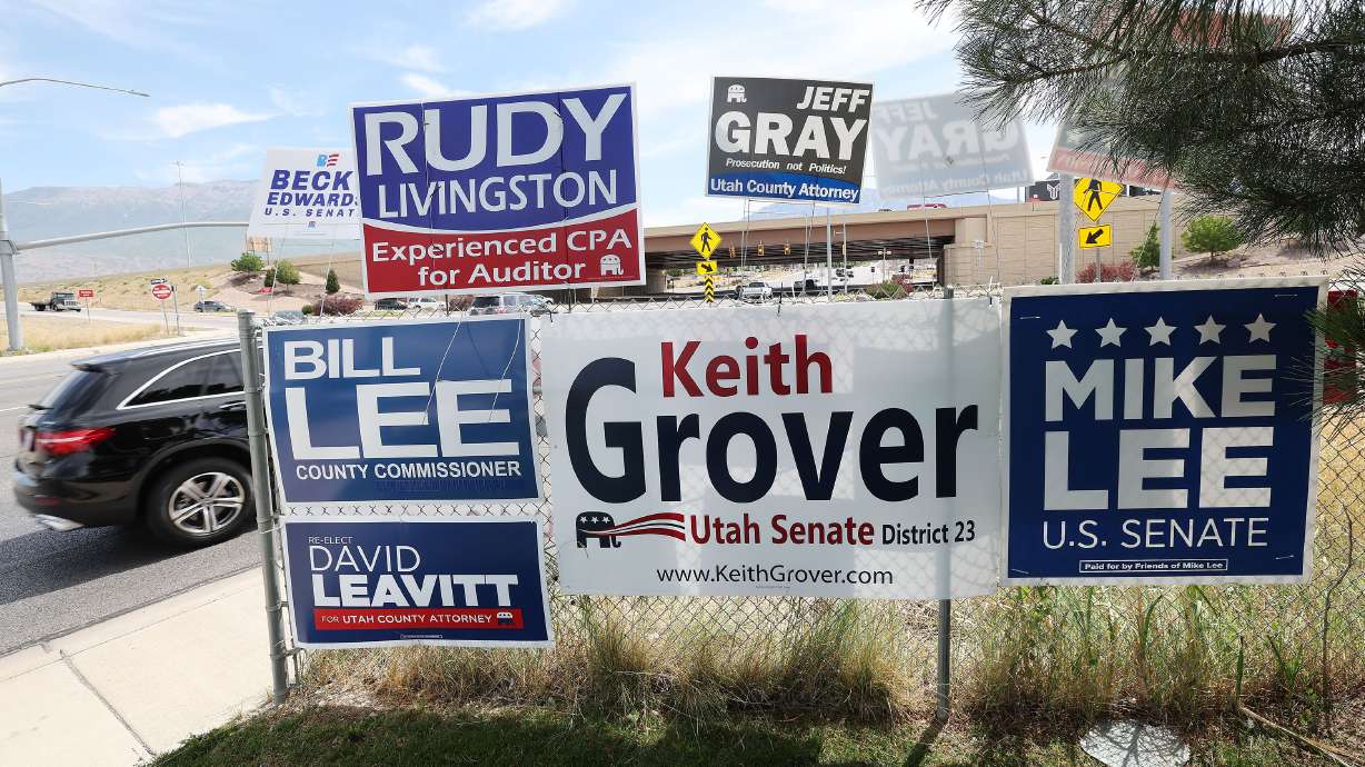 Campaign signs are displayed near I-15 in Orem on June 22, 2022. The Utah Department of Transportation sent a letter to 2023 candidates reminding them to keep signs away from any state rights of way.