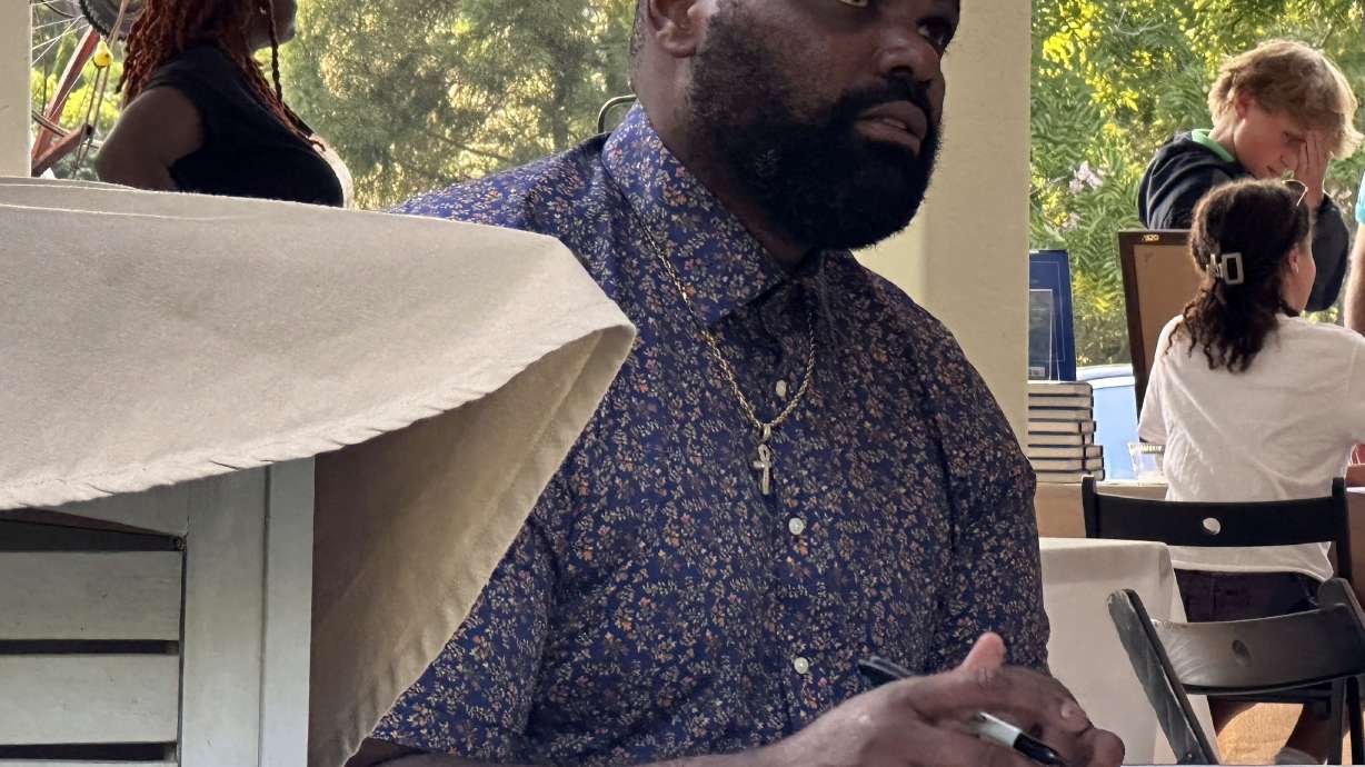 Former NFL player Michael Oher, whose story became the inspiration for the Oscar-nominated movie “The Blind Side,” signs books at an event for his new memoir at a store in Baltimore, Monday, Aug. 21, 2023. Last week, Oher sued Sean and Leah Anne Tuohy to lift his conservatorship with them.
