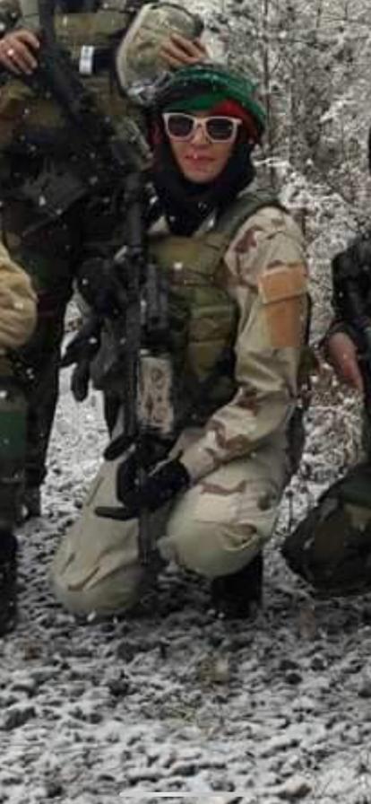 Sima, a member of the Female Tactical Platoon, poses for a photo in full combat gear.