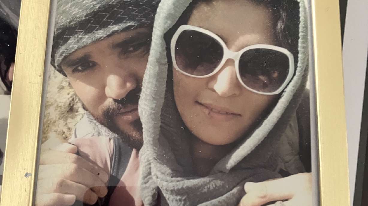 Sima travels with this framed photo of herself with her husband who died while on military duty during Afghan elections in 2019. She is one of 43 Afghan women from the Afghan Army's Female Tactical Platoon now living in the U.S.