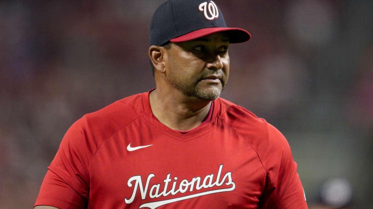 Washington Nationals manager Dave Martinez walks to the dugout after making a pitching change during the ninth inning of a baseball game against the Cincinnati Reds, Friday, Aug. 4, 2023, in Cincinnati.