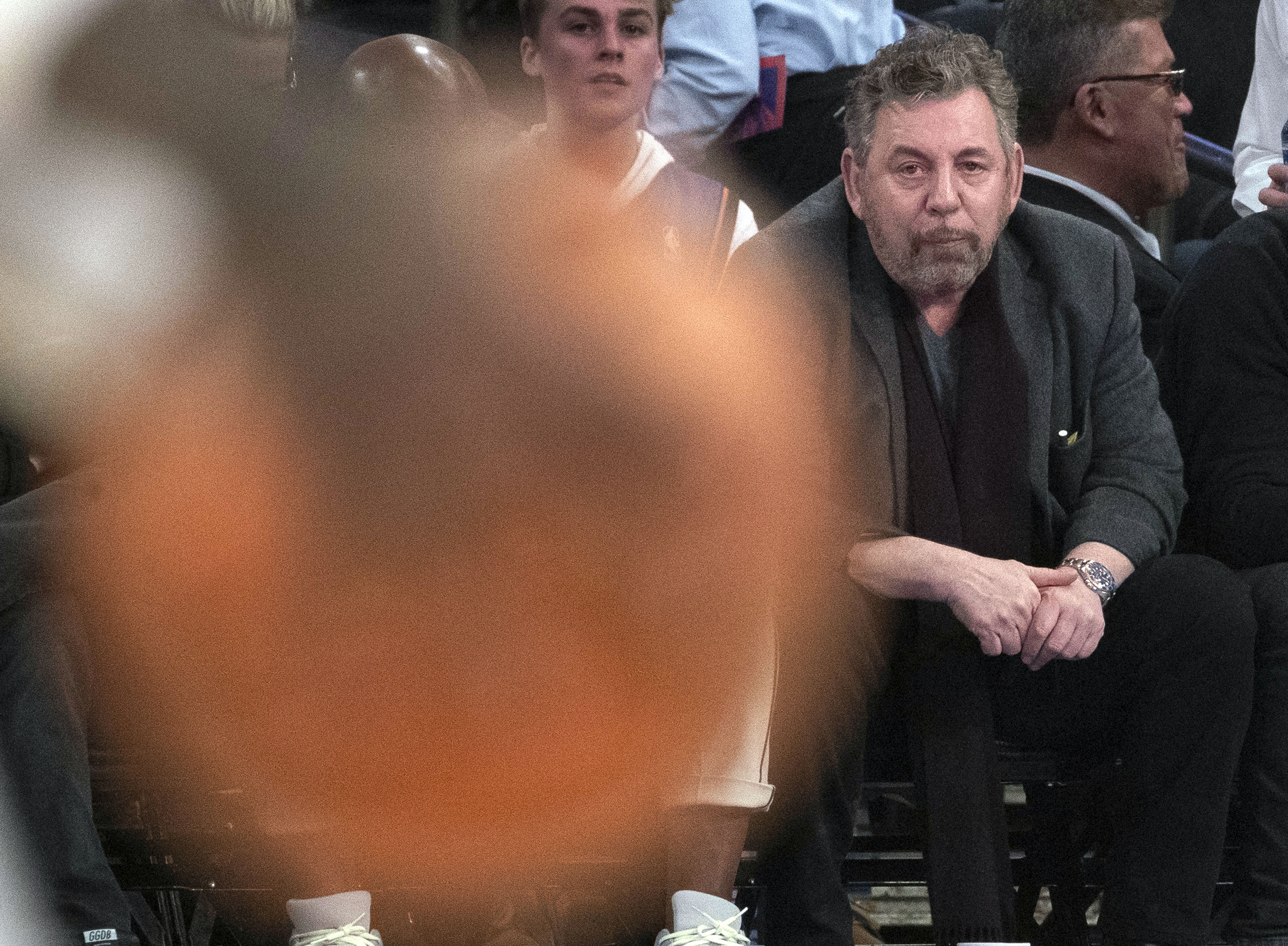 FILE - New York Knicks owner James Dolan, front right, watches the first half of an NBA basketball game March 6, 2020, at Madison Square Garden in New York. The Knicks are suing the Toronto Raptors, and a former Knicks employee Monday, Aug. 21, 2023, saying the worker stole thousands of videos and other scouting secrets to give to his new Canadian employer.