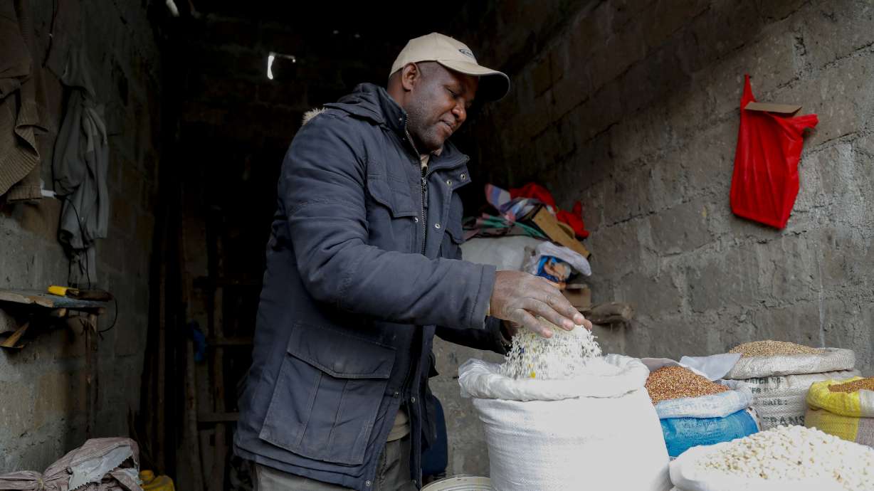 Vendor Francis Ndege measures rice at his stall in the Toi Market, Nairobi, Kenya on Aug. 9. Countries worldwide are scrambling to secure rice after a partial ban on exports by India cut global supplies by roughly a fifth.