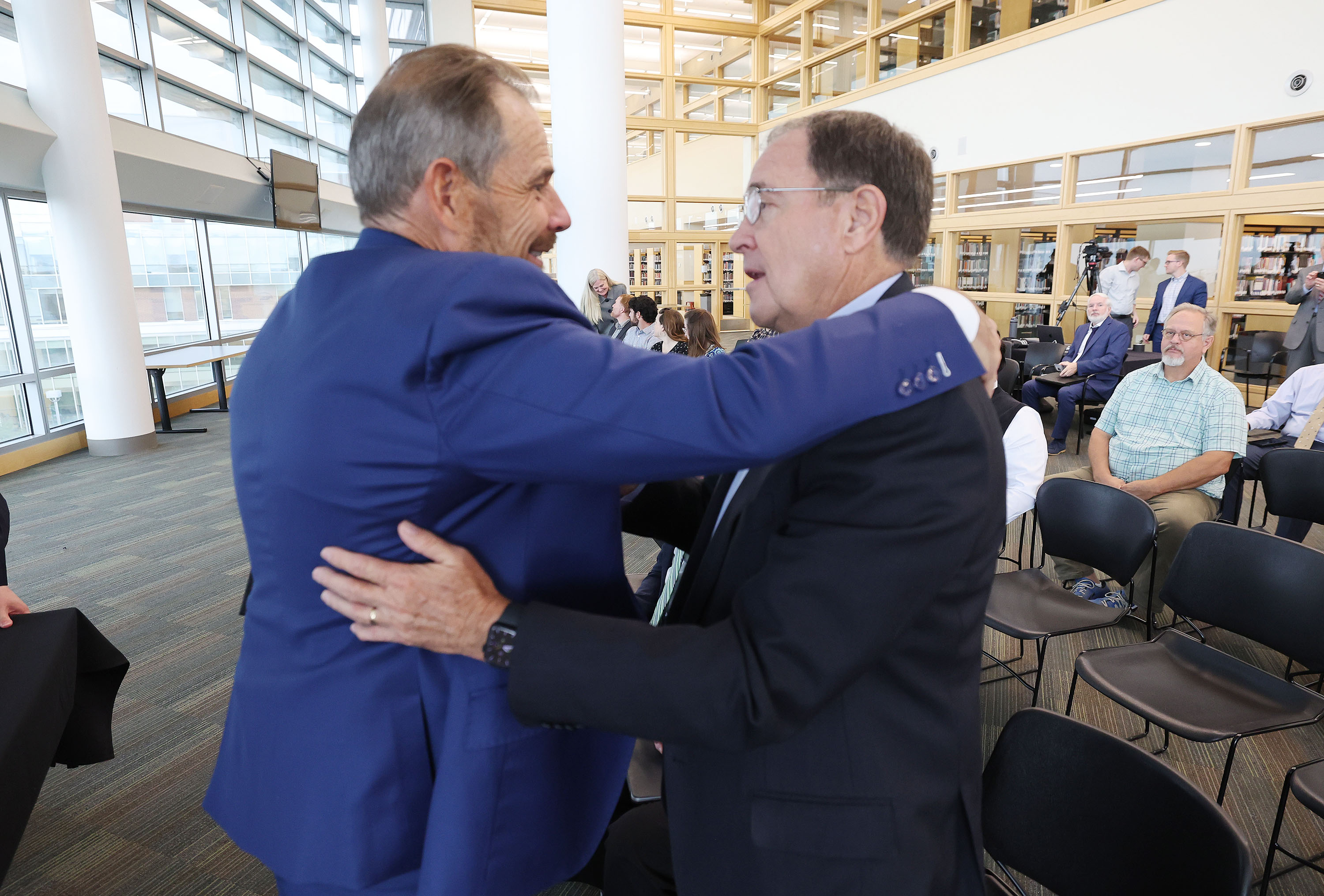 Rep. John Curtis, R-Utah, hugs former Utah Governor Gary Herbert after speaking during the Sutherland Institute's 2023 Congressional Series in Orem on Tuesday.