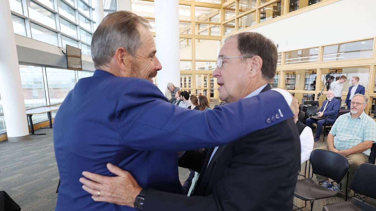 Rep. John Curtis, R-Utah, hugs former Utah Governor Gary Herbert after speaking during the Sutherland Institute's 2023 Congressional Series in Orem on Tuesday.