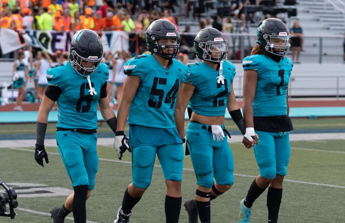 Jake Metcalfe, second from right, walks with the fellow Farmington team captains before a game.