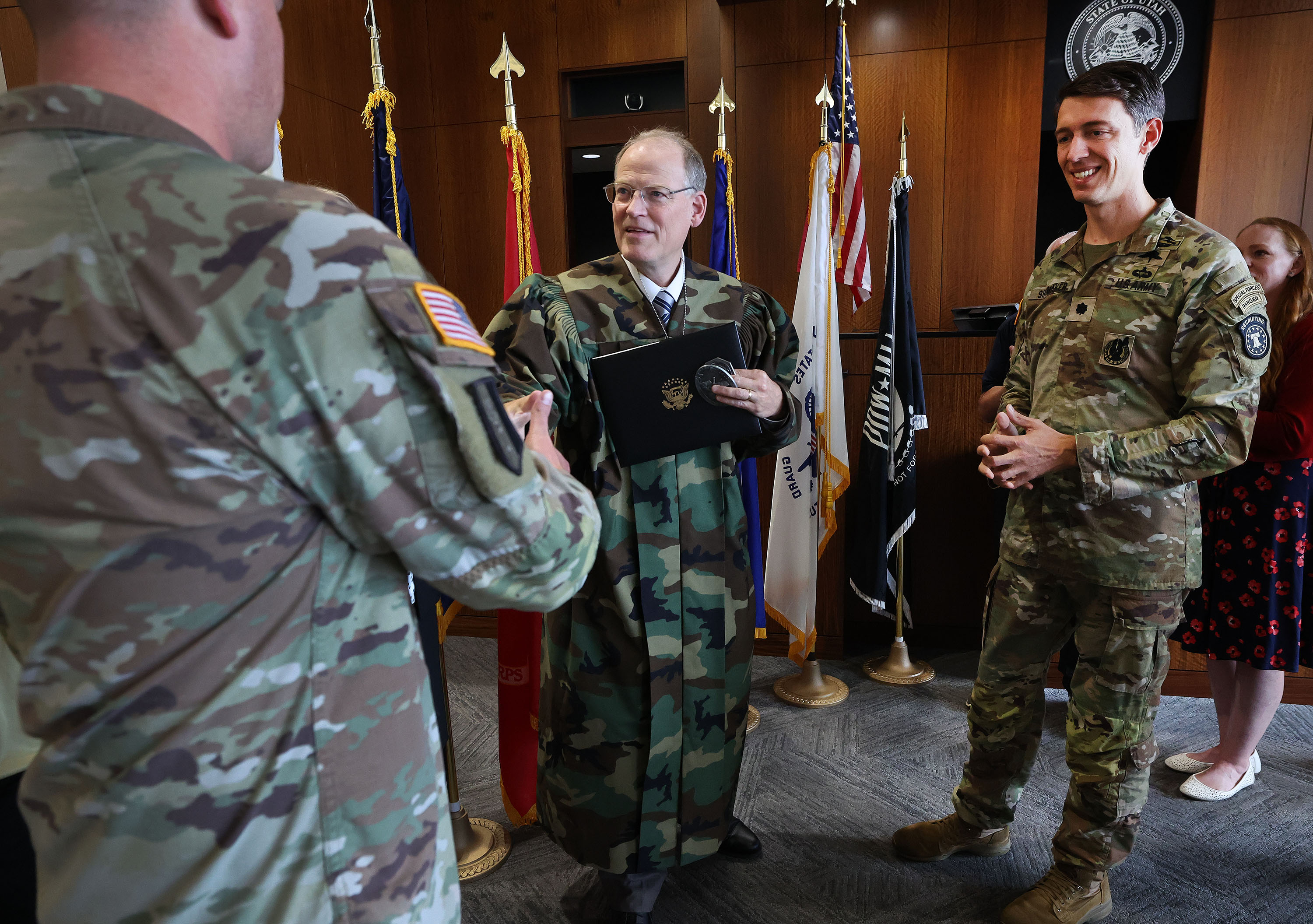 Judge Kraig Powell smiles after receiving a camouflage robe given to him in his courtroom at the Provo District Courthouse in Provo on Tuesday. The robe signifies his contribution to the local veteran community.