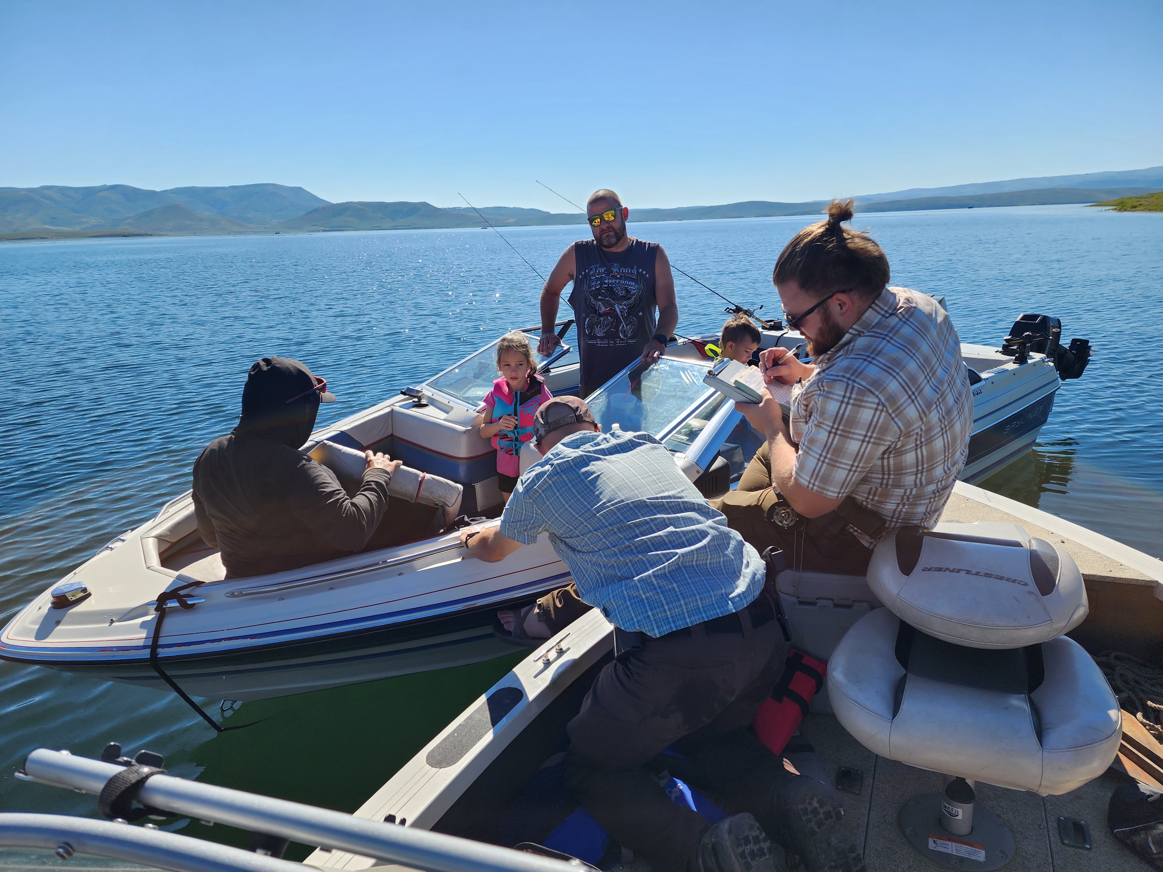 Utah Division of Wildlife Resources conservation officers Devin Shirley and McKay Braley conduct a boat inspection on Strawberry Reservoir.