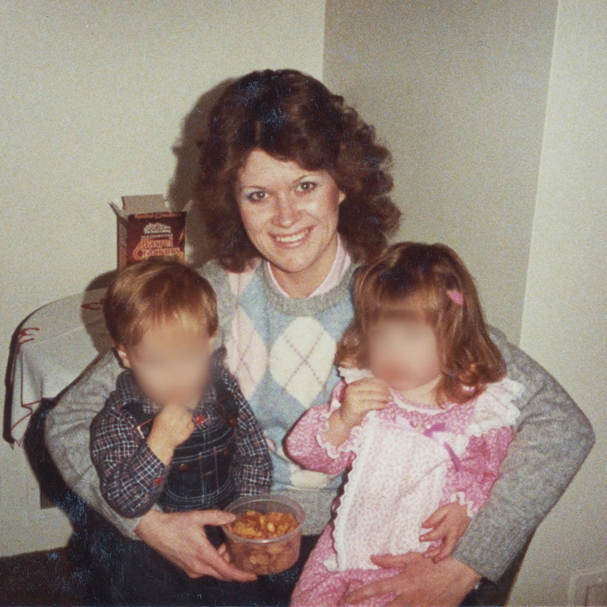 Sheree Warren holds two young children in this undated photo. The children’s faces have been obscured by COLD to protect their privacy.
