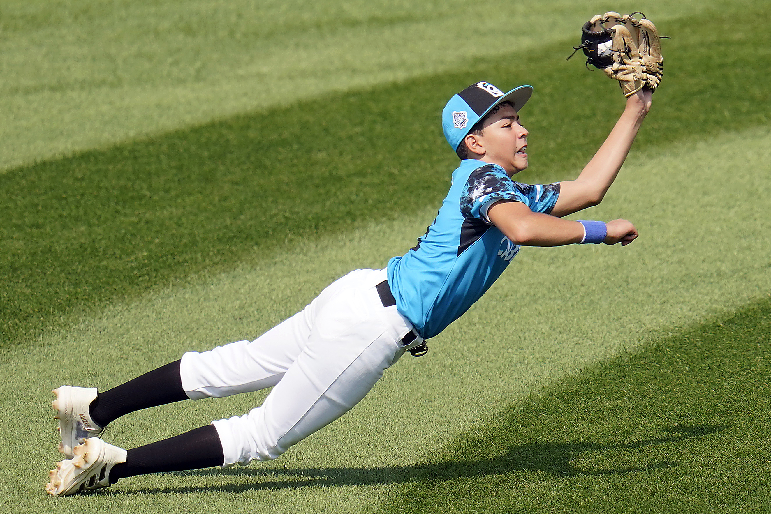 Curacao left fielder Nasir El-Ossais makes a diving catch on a ball hit by Venezuela's Osman Basabe during the fourth inning of a baseball game at the Little League World Series tournament in South Williamsport, Pa., Monday, Aug. 21, 2023. 