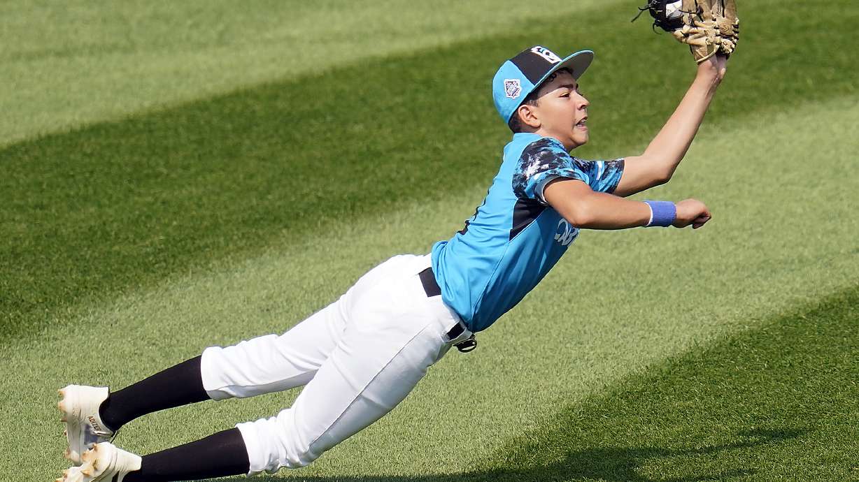 Curacao left fielder Nasir El-Ossais makes a diving catch on a ball hit by Venezuela's Osman Basabe during the fourth inning of a baseball game at the Little League World Series tournament in South Williamsport, Pa., Monday, Aug. 21, 2023.