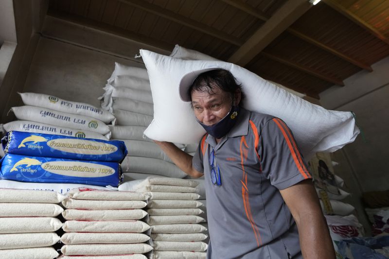 A worker carries a rice sack in Bangkok, Thailand, on Aug. 10, . Countries worldwide are scrambling to secure rice after a partial ban on exports by India cut supplies by roughly a fifth.