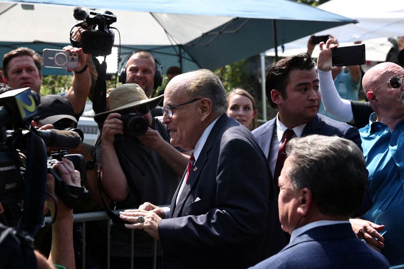 Rudy Giuliani speaks to reporters outside the Fulton County Jail in Atlanta on Wednesday.