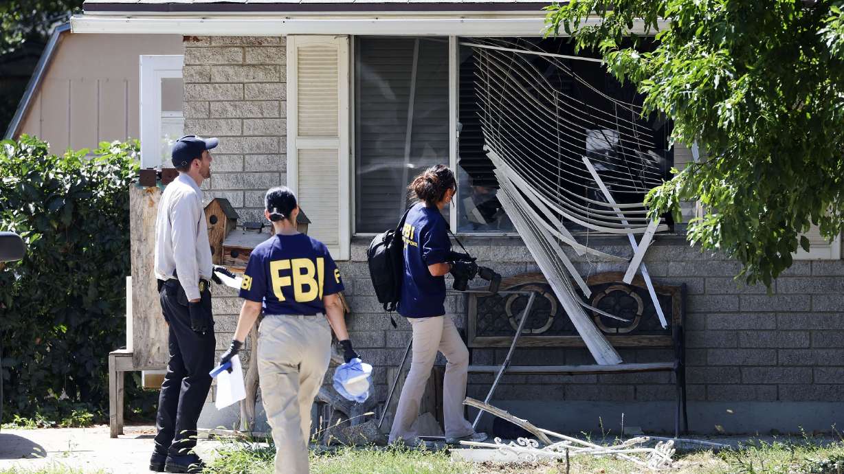Law enforcement agents investigate at the home of Craig Deeleuw Robertson, who was shot and killed by FBI agents, in Provo on Aug. 9. Robertson posted threatening comments about President Joe Biden hours before the president visited Utah.