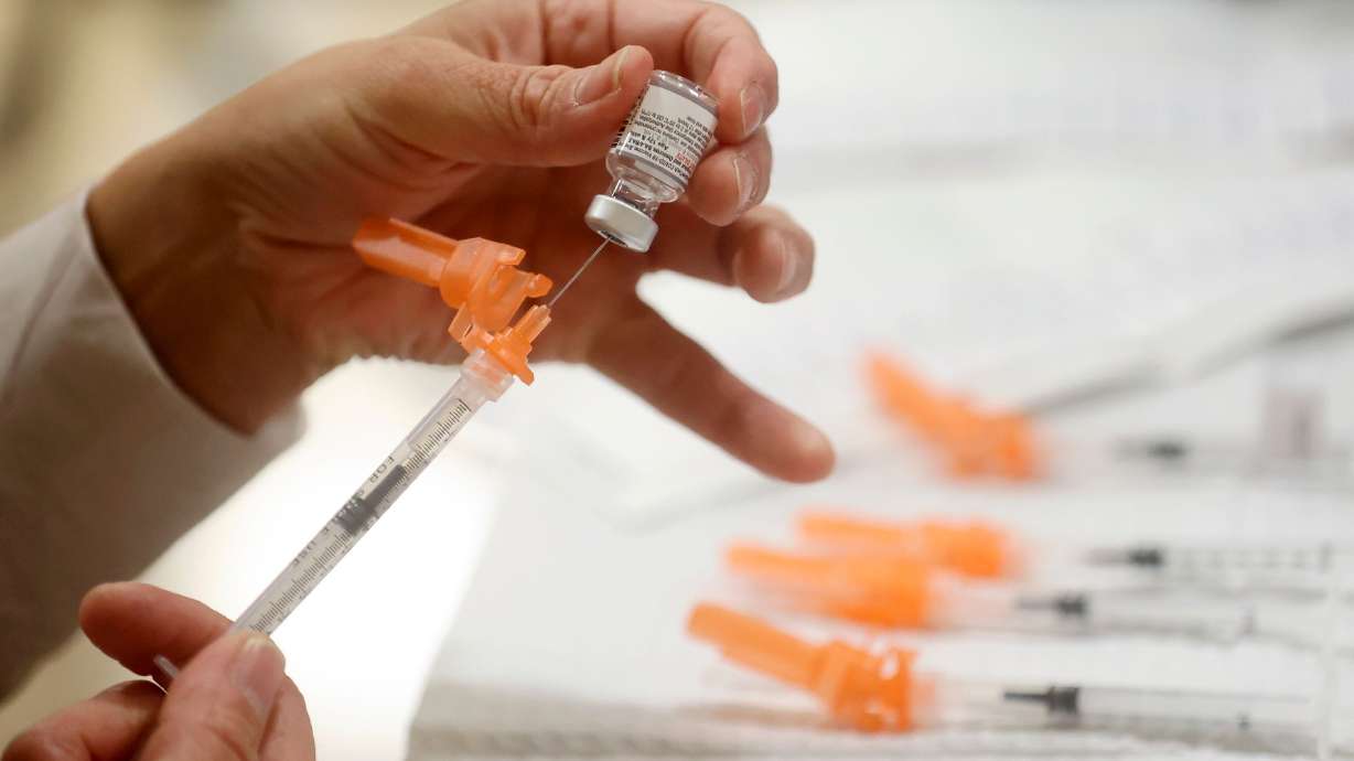 A Salt Lake County Health Department employee prepares Pfizer COVID-19 booster shots. As the COVID-19 era nears its fourth year, the response is changing but community heath experts still have similar recommendations.