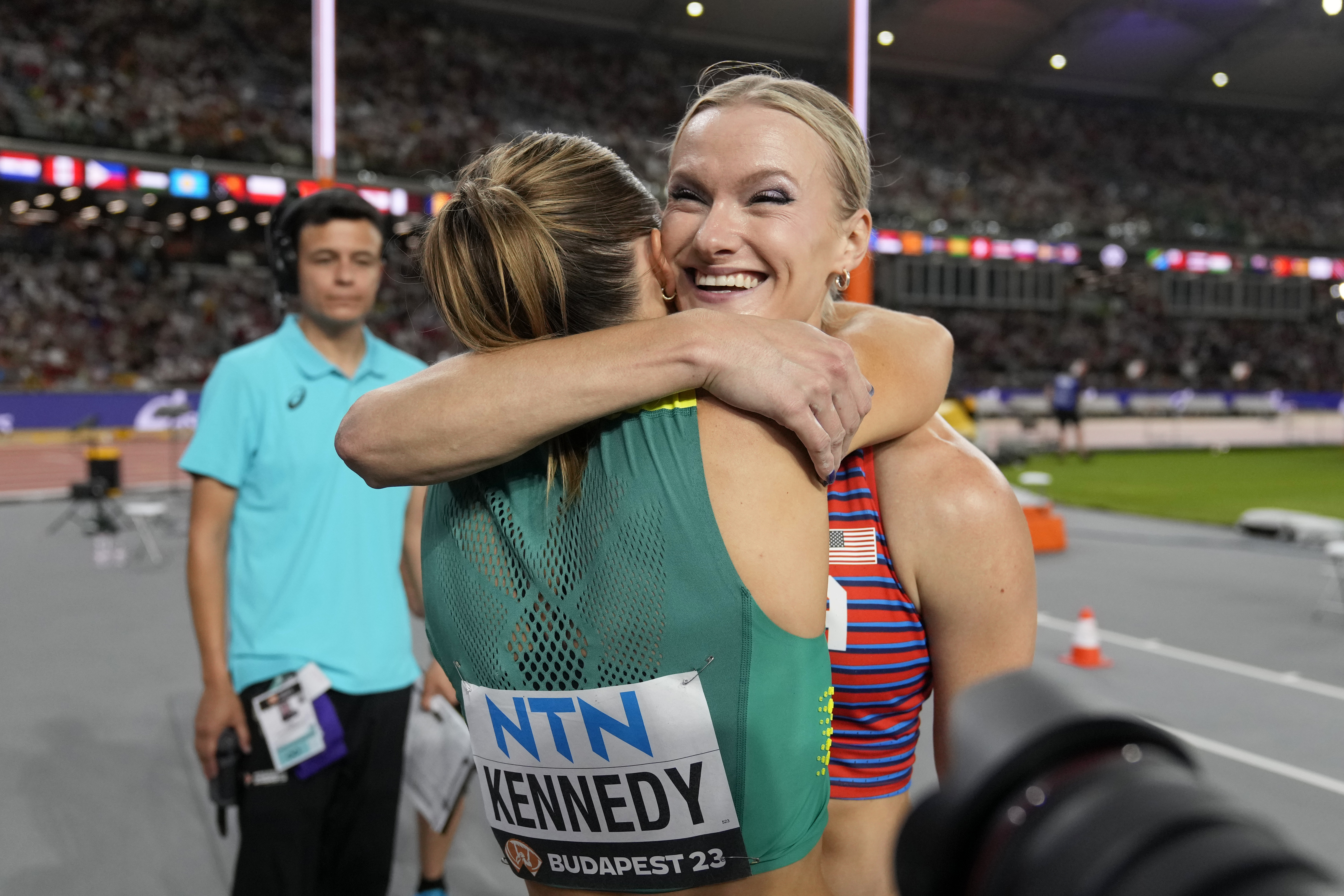 Katie Moon, of the United States, and Nina Kennedy, of Australia, left hug each other after sharing the gold medal in the Women's pole vault final during the World Athletics Championships in Budapest, Hungary, Wednesday, Aug. 23, 2023. 