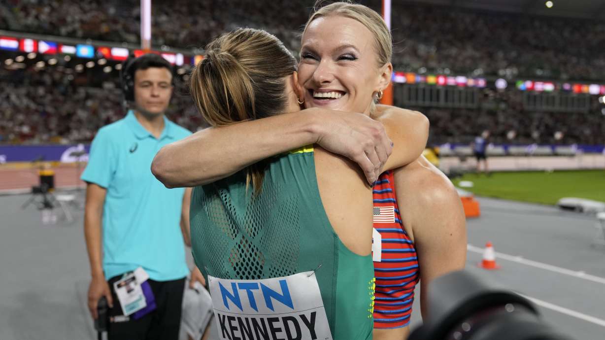 Katie Moon, of the United States, and Nina Kennedy, of Australia, left hug each other after sharing the gold medal in the Women's pole vault final during the World Athletics Championships in Budapest, Hungary, Wednesday, Aug. 23, 2023.