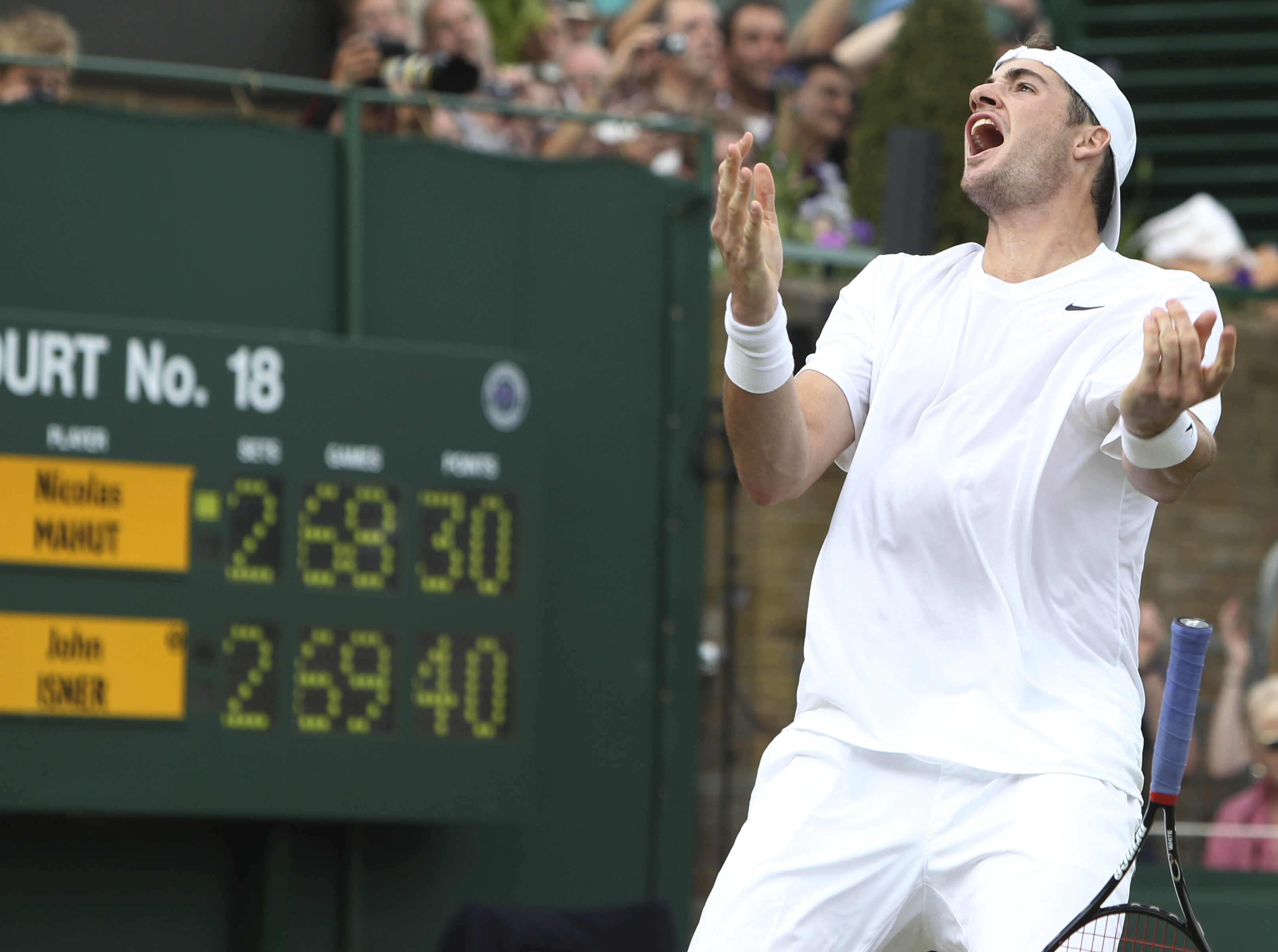 FILE - John Isner, of the United States, reacts as he defeats France's Nicolas Mahut in their men's singles match at the All England Lawn Tennis Championships at Wimbledon, June 24, 2010. Isner will retire from professional tennis after playing at the U.S. Open, he announced Wednesday, Aug. 23, 2023, bringing an end to a career that included one Grand Slam semifinal appearance and a victory in the longest match in the sport's history. 