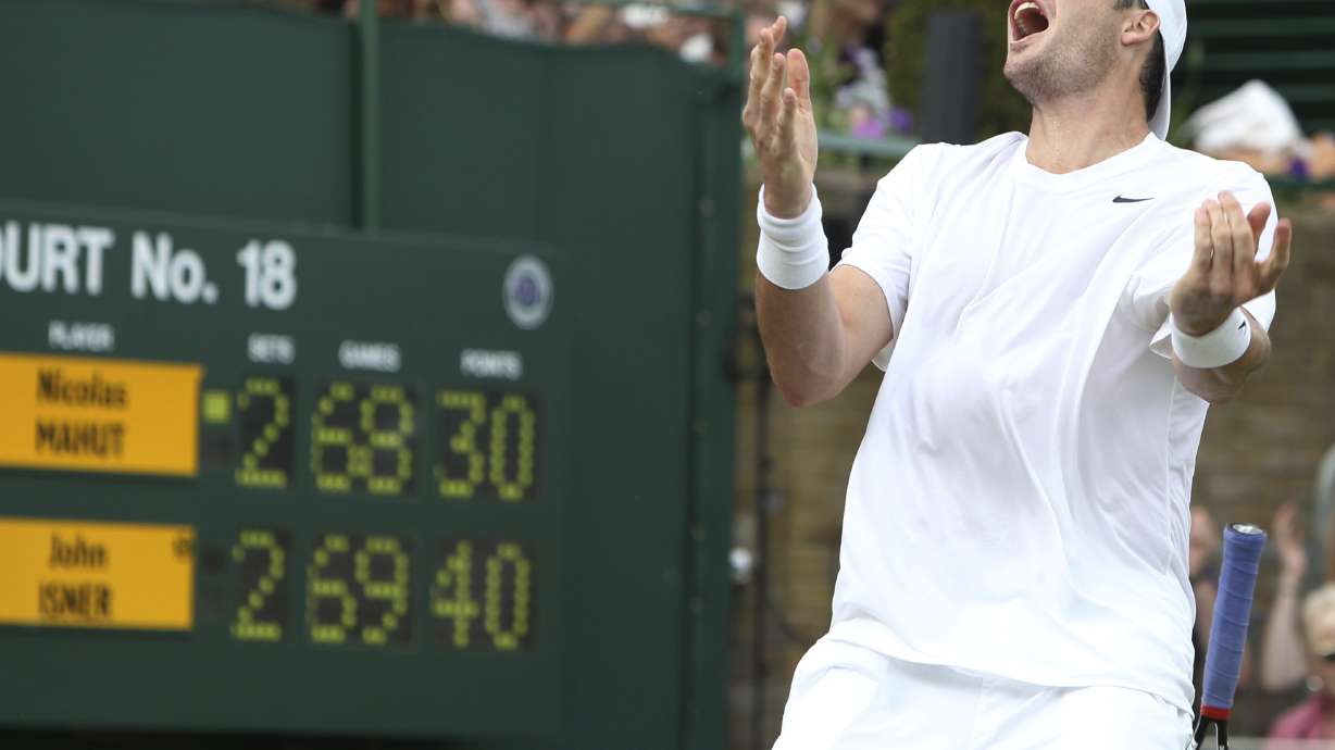 FILE - John Isner, of the United States, reacts as he defeats France's Nicolas Mahut in their men's singles match at the All England Lawn Tennis Championships at Wimbledon, June 24, 2010. Isner will retire from professional tennis after playing at the U.S. Open, he announced Wednesday, Aug. 23, 2023, bringing an end to a career that included one Grand Slam semifinal appearance and a victory in the longest match in the sport's history.