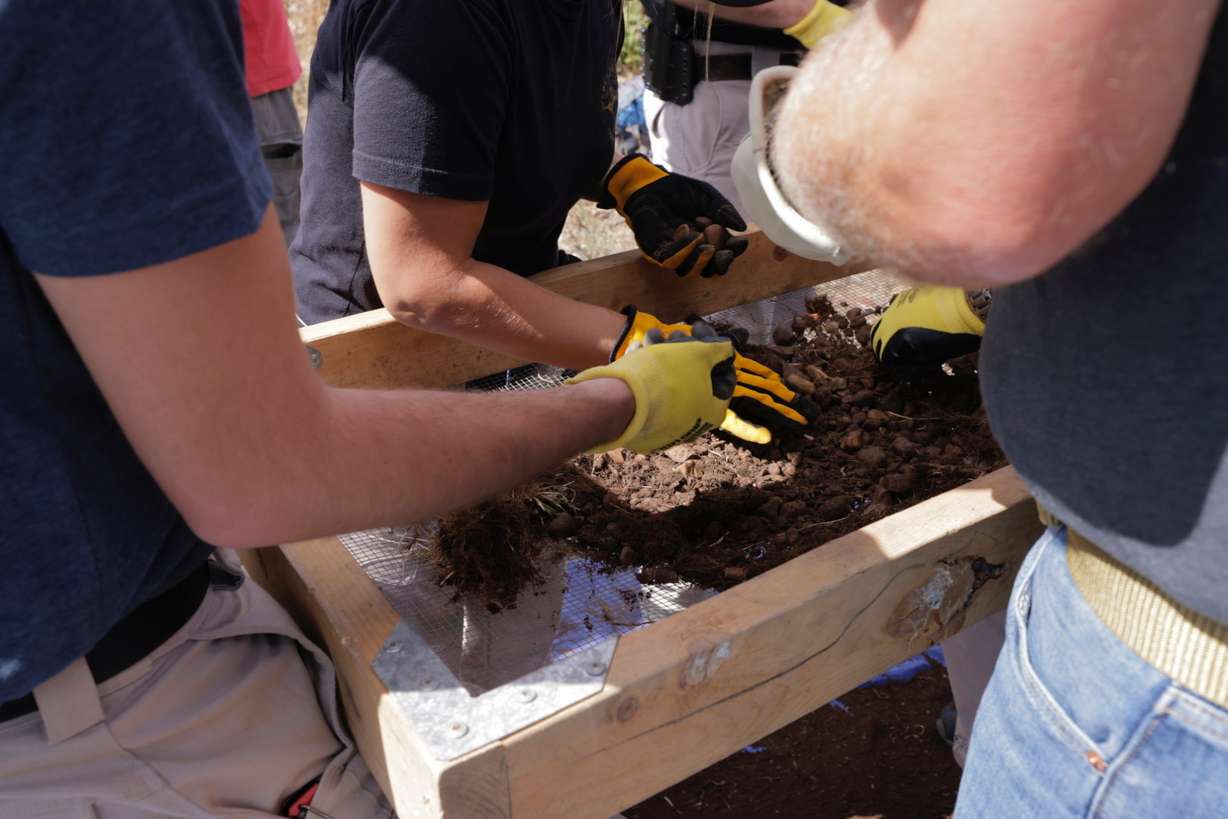 Law enforcement investigators exhume a possible burial site in the area of Causey Reservoir Reservoir on Wednesday as part of a cold case investigation.