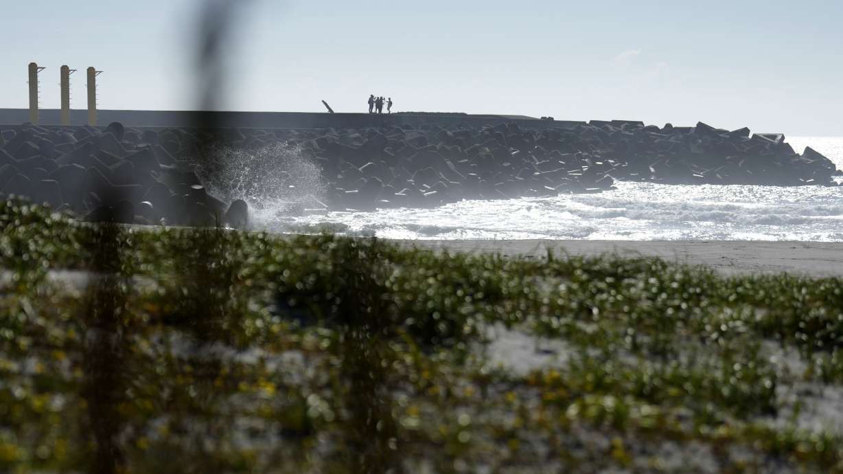 Journalists film the Fukushima Daiichi nuclear power plant, damaged by a massive March 11, 2011, earthquake and tsunami. It was to start releasing treated and diluted radioactive wastewater into the Pacific Ocean as early as Thursday.
