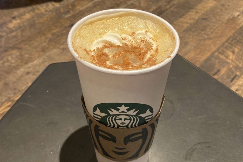 A Pumpkin Spice Latte drink rests on a table at a Starbucks in New York on Thursday. The seasonal drink that made pumpkin spice a star is marking two decades in the world.