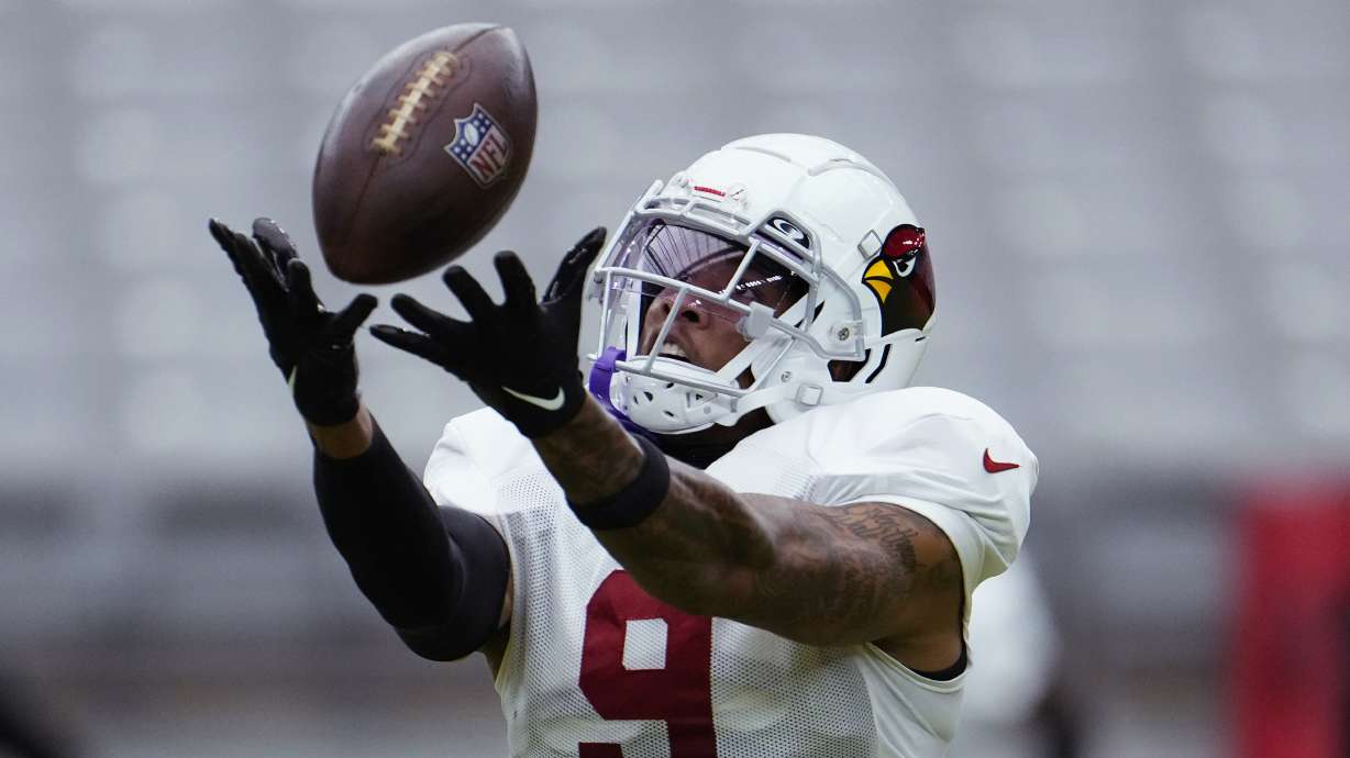 Arizona Cardinals linebacker Isaiah Simmons reaches up to make a catch during NFL football training camp Thursday, Aug. 3, 2023, in Glendale, Ariz.