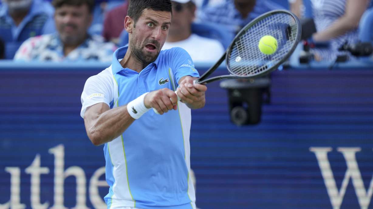 Novak Djokovic, of Serbia, returns a shot to Carlos Alcaraz, of Spain, during the men's singles final of the Western & Southern Open tennis tournament, Sunday, Aug. 20, 2023, in Mason, Ohio.