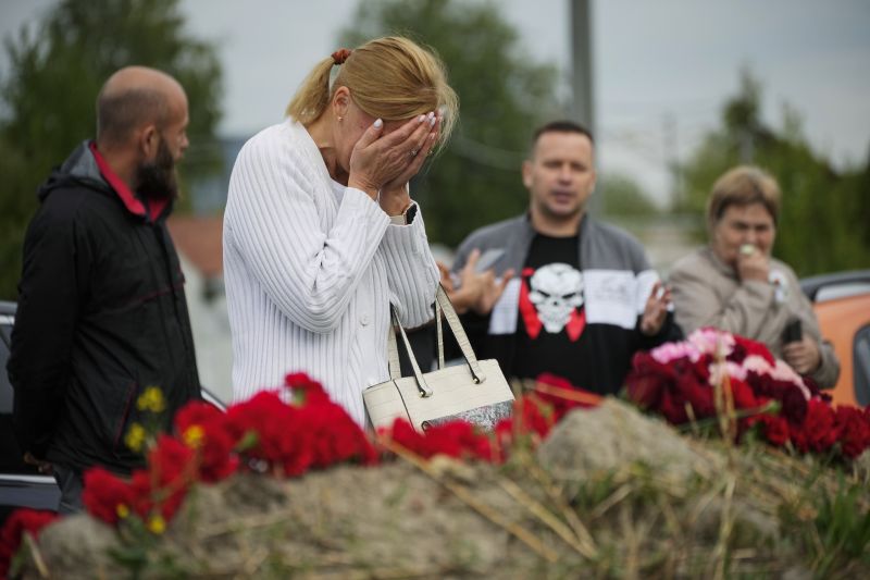 A woman reacts at an informal memorial next to the former 'PMC Wagner Centre' in St. Petersburg, Russia, Thursday. Russian mercenary leader Yevgeny Prigozhin, the founder of the Wagner Group, reportedly died when a private jet he was said to be on crashed on Wednesday, killing all 10 people on board.