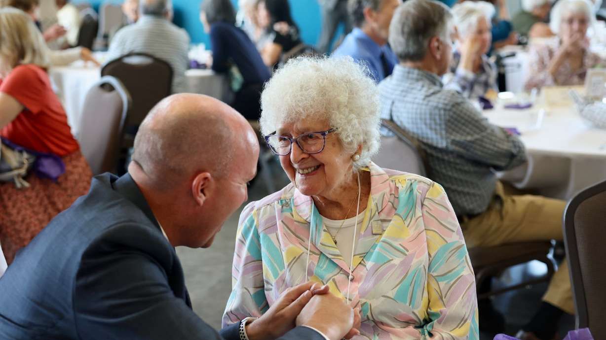 Utah Gov. Spencer Cox visits with Cleo Barthule, 101, at an event celebrating Utah's 145 centenarians at the Viridian Event Center in West Jordan on Thursday.