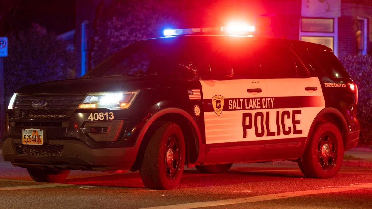 Members of the Crash Analysis Reconstruction Team investigate a critical injury crash at 600 South and 700 East in Salt Lake City on Friday.
