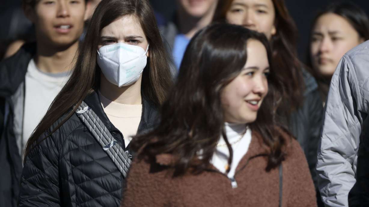 A young woman wears a KN95 mask in downtown Salt Lake City on Jan. 26, 2022. Mask mandates are already in place at a few private entities, but claims federal officials are readying restrictions called ‘utterly false.'