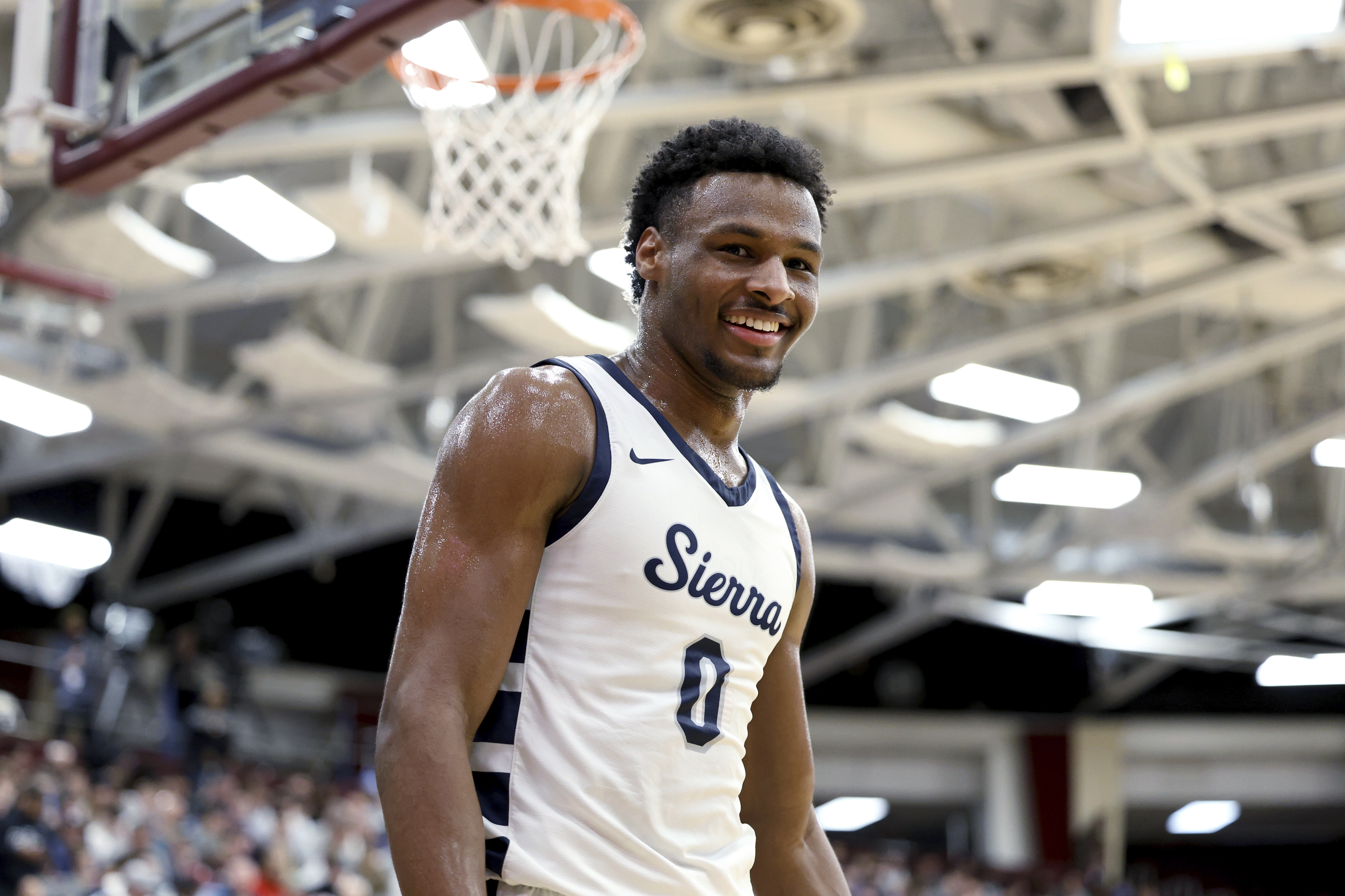 Sierra Canyon's Bronny James smiles during a high school basketball game against Christopher Columbus at the Hoophall Classic, Jan. 16, in Springfield, Mass. Bronny James went into cardiac arrest during a basketball workout at the University of Southern California last month because of a congenital heart defect.