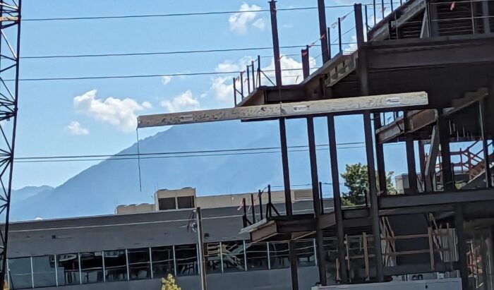 A forklift moves a foundational beam at the site of Salt Lake County’s new Crisis Care Center.