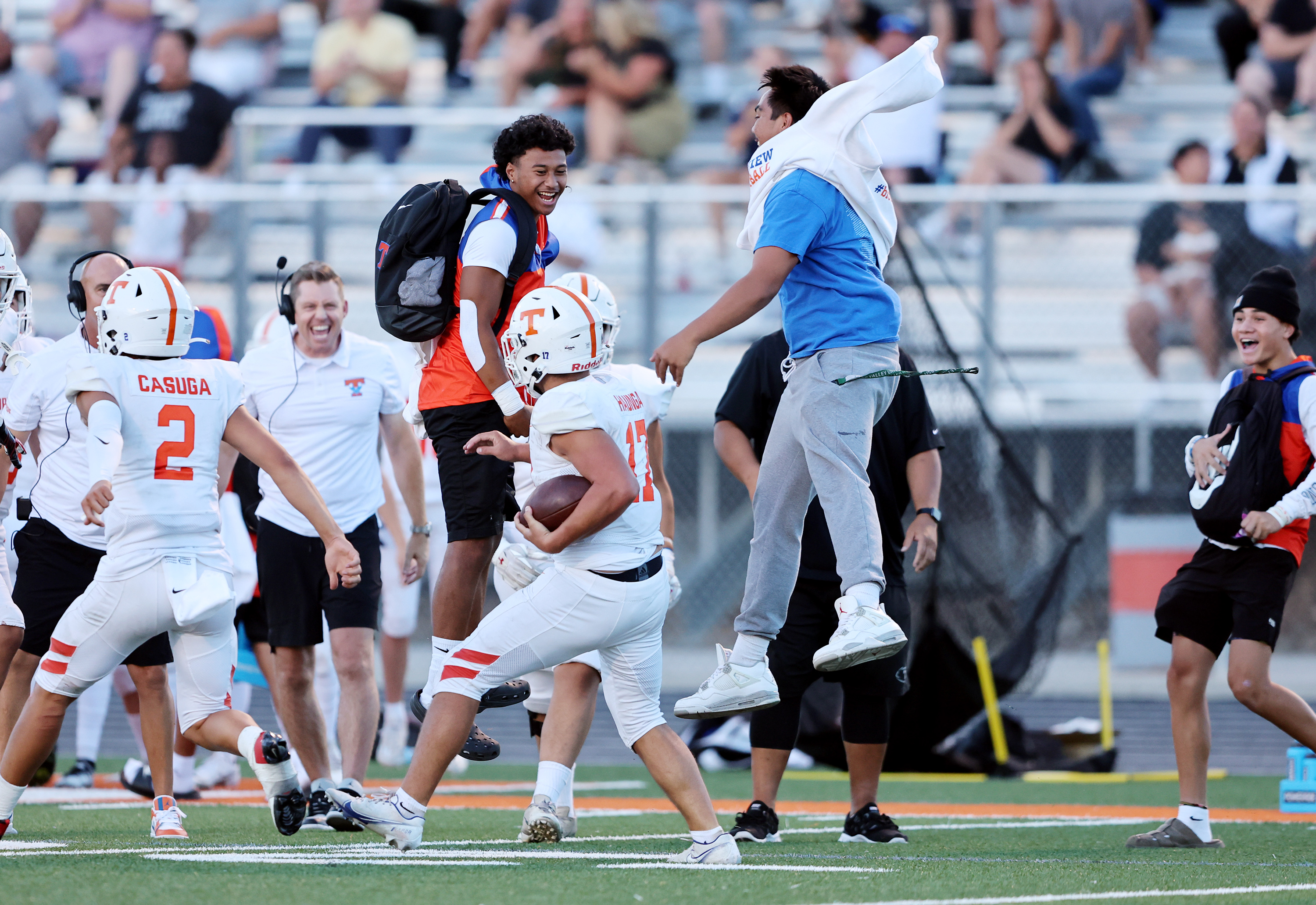 Timpview's Helaman Casuga (2) and Paka Haunga celebrate a big play on the sideline against Skyridge in Lehi on Friday, Aug. 11, 2023. Skyridge won 26-14.