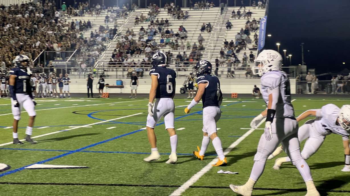 Corner Canyon players walk away after a defensive play against Lone Peak.
