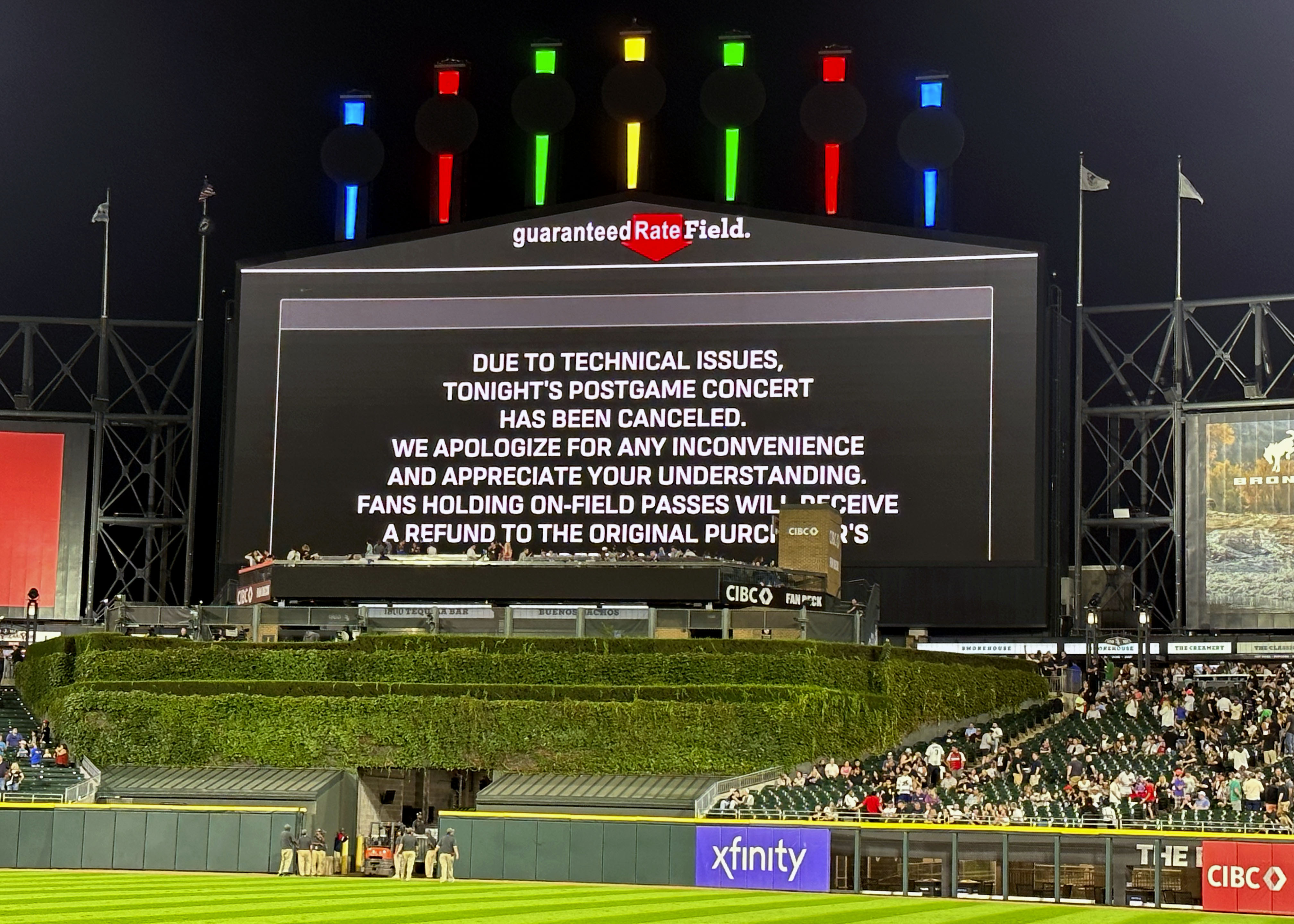 A message on the main scoreboard at Guaranteed Rate Field announces the cancellation of an 90s concert that was to feature Vanilla Ice, Tone Loc, and Rob Base after a baseball game between the Chicago White Sox and the Oakland Athletics, Friday, Aug. 25, 2023, in Chicago. 