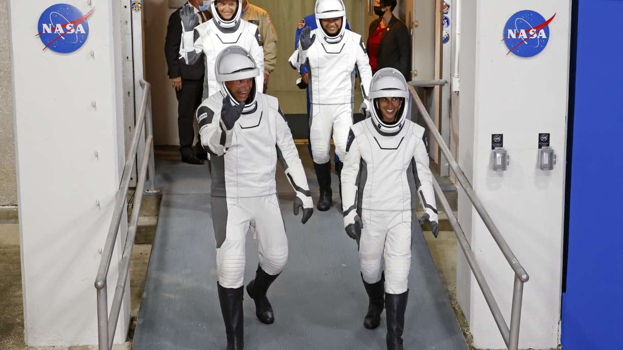 Danish astronaut Andreas Mogensen, front left, NASA astronaut Jasmin Moghbeli, front right, Russian cosmonaut Konstantin Borisov, back left, and Japanese astronaut Satoshi Furukawa leave the Operations and Checkout Building before heading to the launch pad to board the SpaceX Falcon 9 rocket on a mission to the International Space Station, at Kennedy Space Center in Cape Canaveral, Fla., early Saturday.