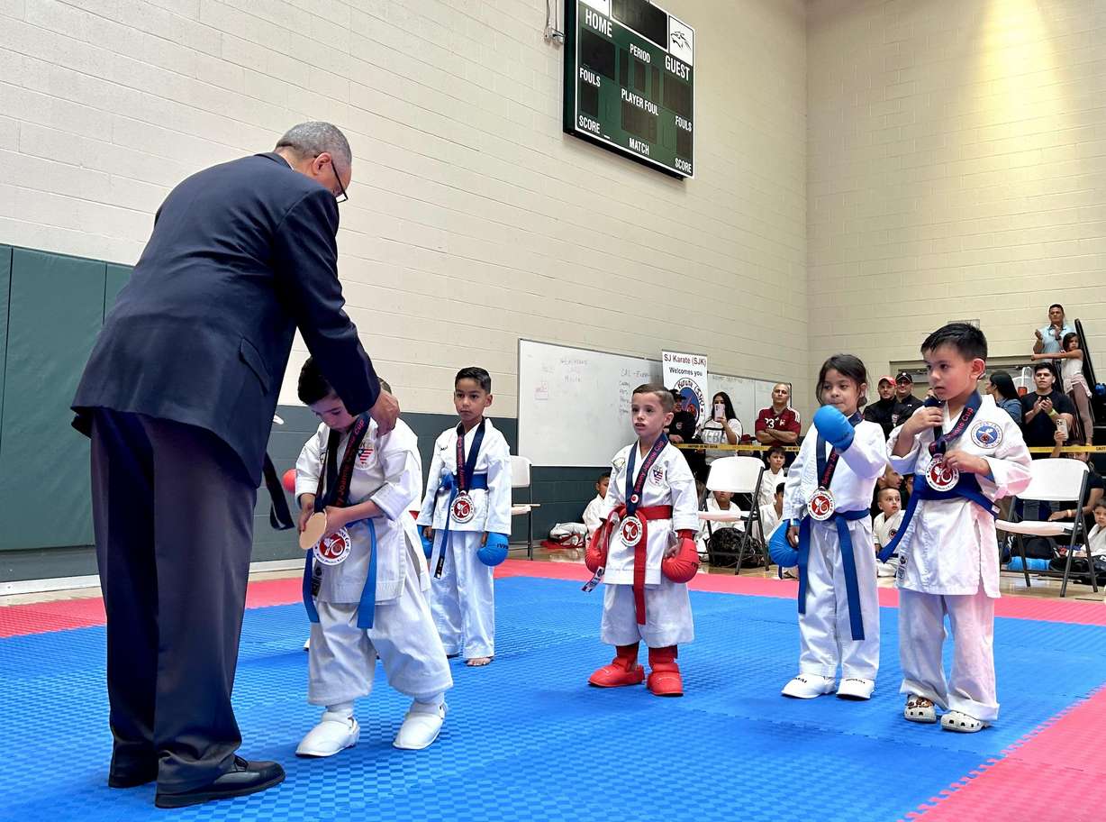 A judge awards a young athlete during the seventh annual Seleny Joanne Karate Championship in Lehi on Saturday. David and Seleny Crosby started the tournament to honor their late daughter, Seleny Joanne, who died in a bus accident at age 10.
